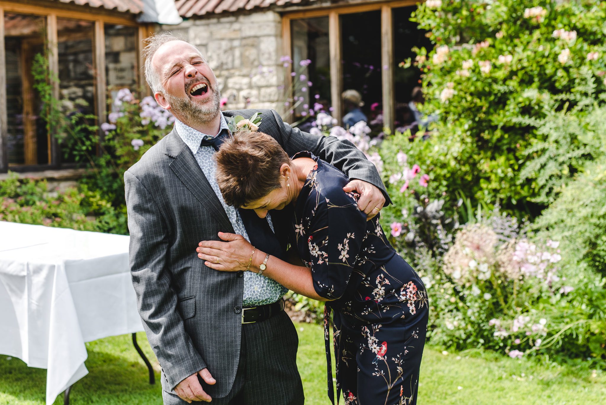 mother and father of thebride giggling at a priston wedding