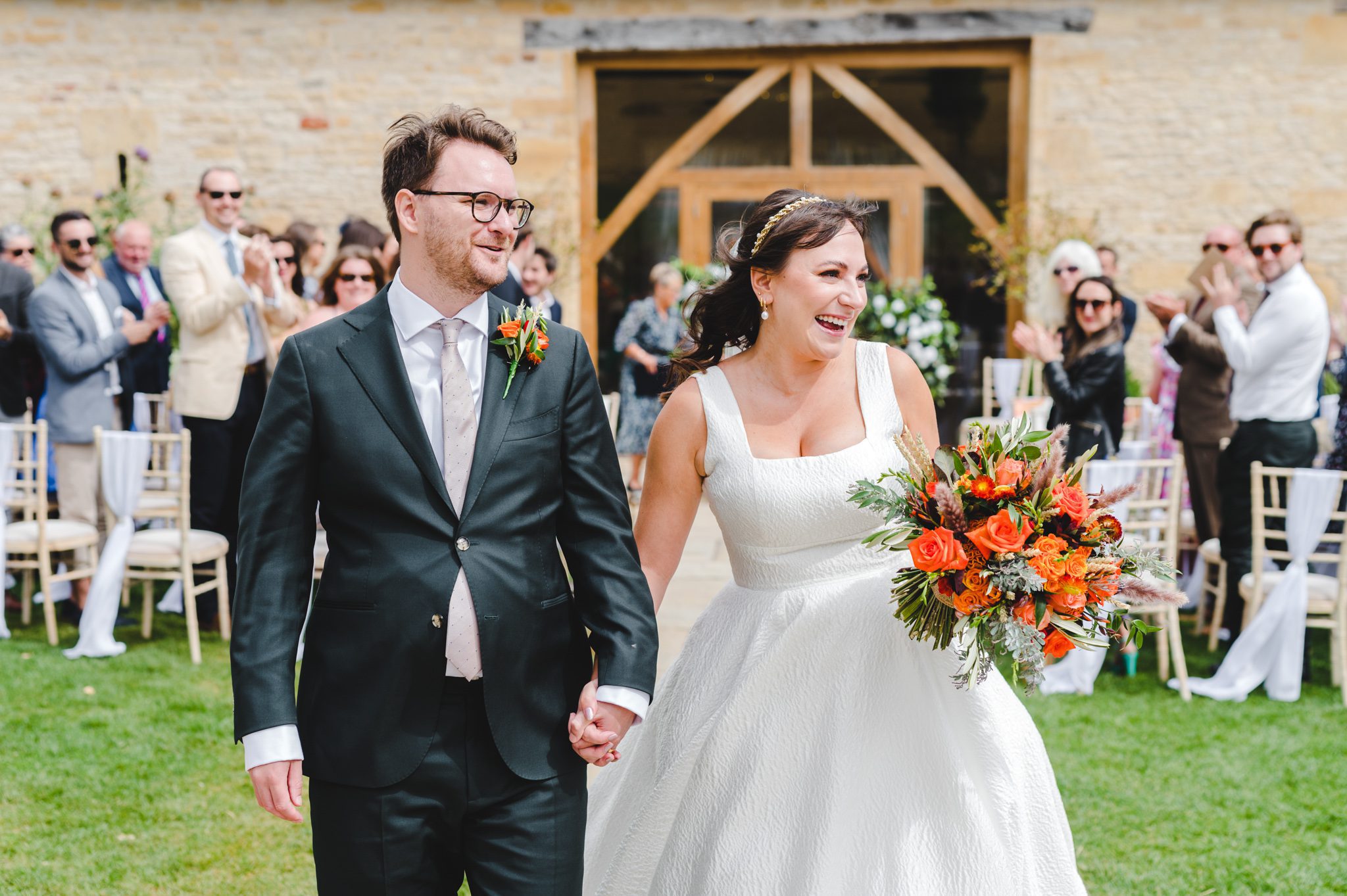 Couple exit down the aisle at Upcote