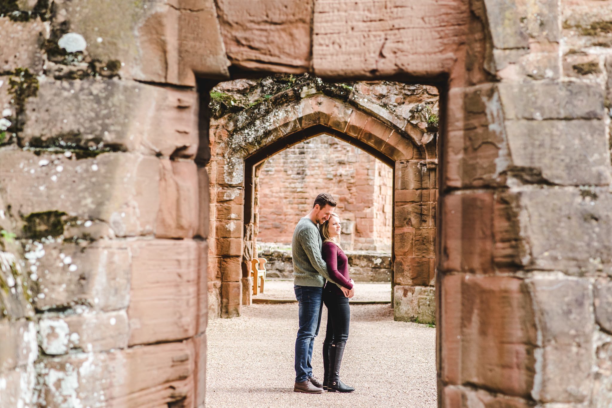 An engaged couple stood in a doorway at Kenilworth Castle