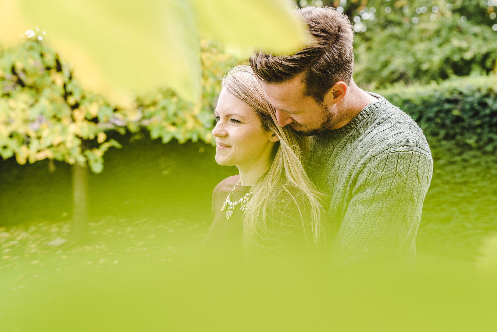 A photo through thre trees of a couple