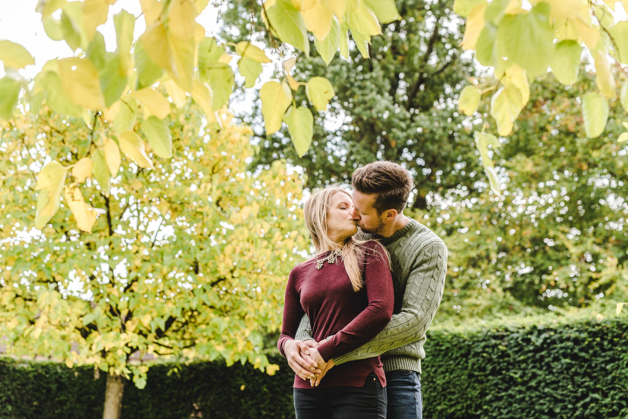 A bride and groom kissing at Kenilworth Castle