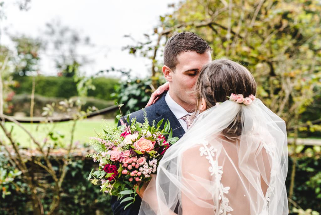Bride and Groom kissing at an autumnal wedding