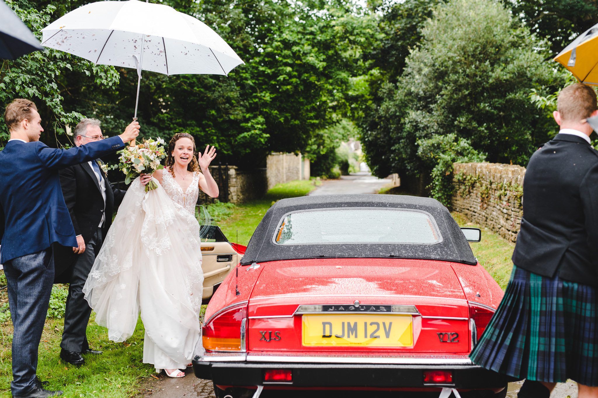 Bride and groom leaving in a Jaguar XJS V12