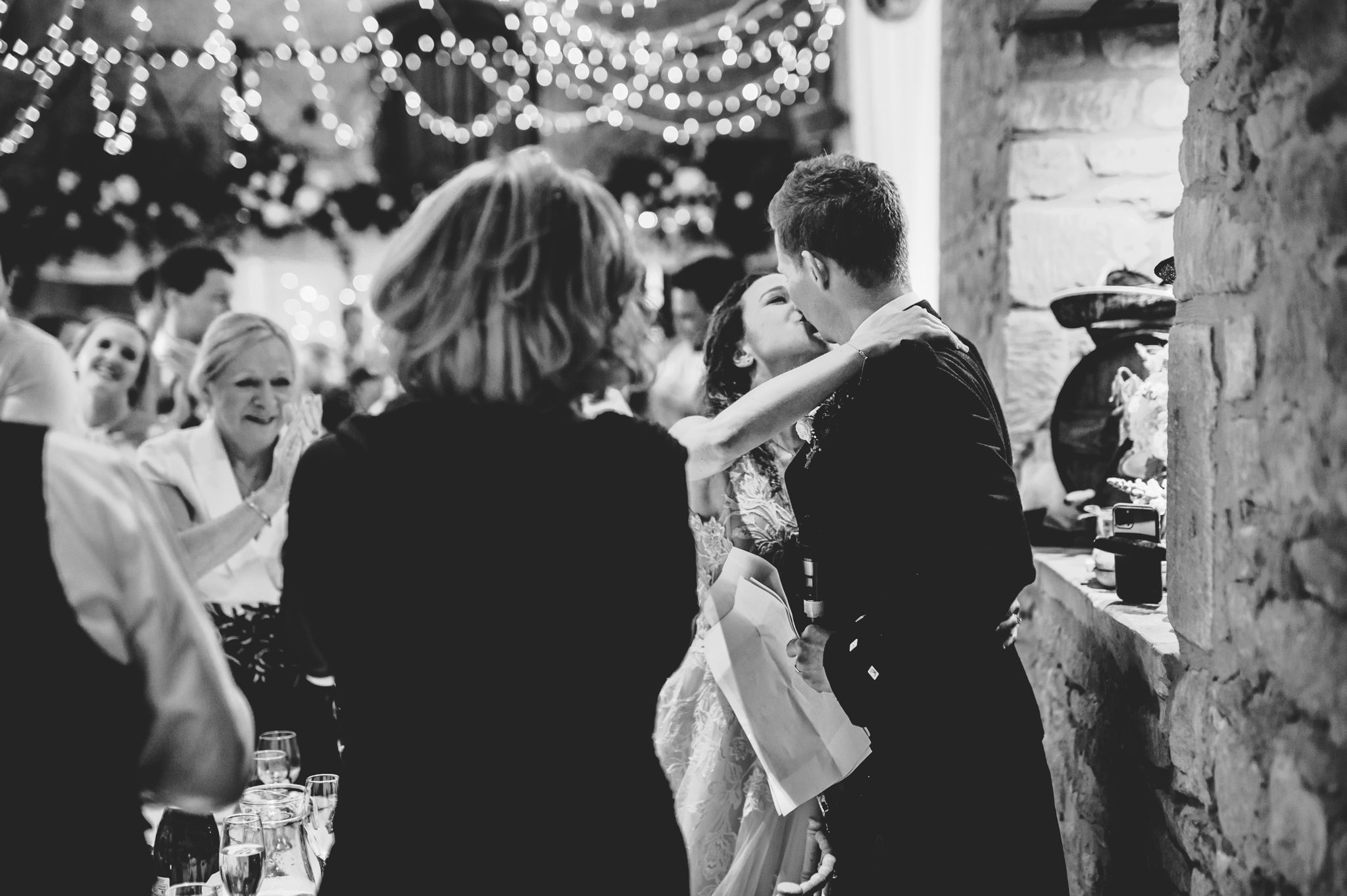 Bride and groom kissing at the great barn