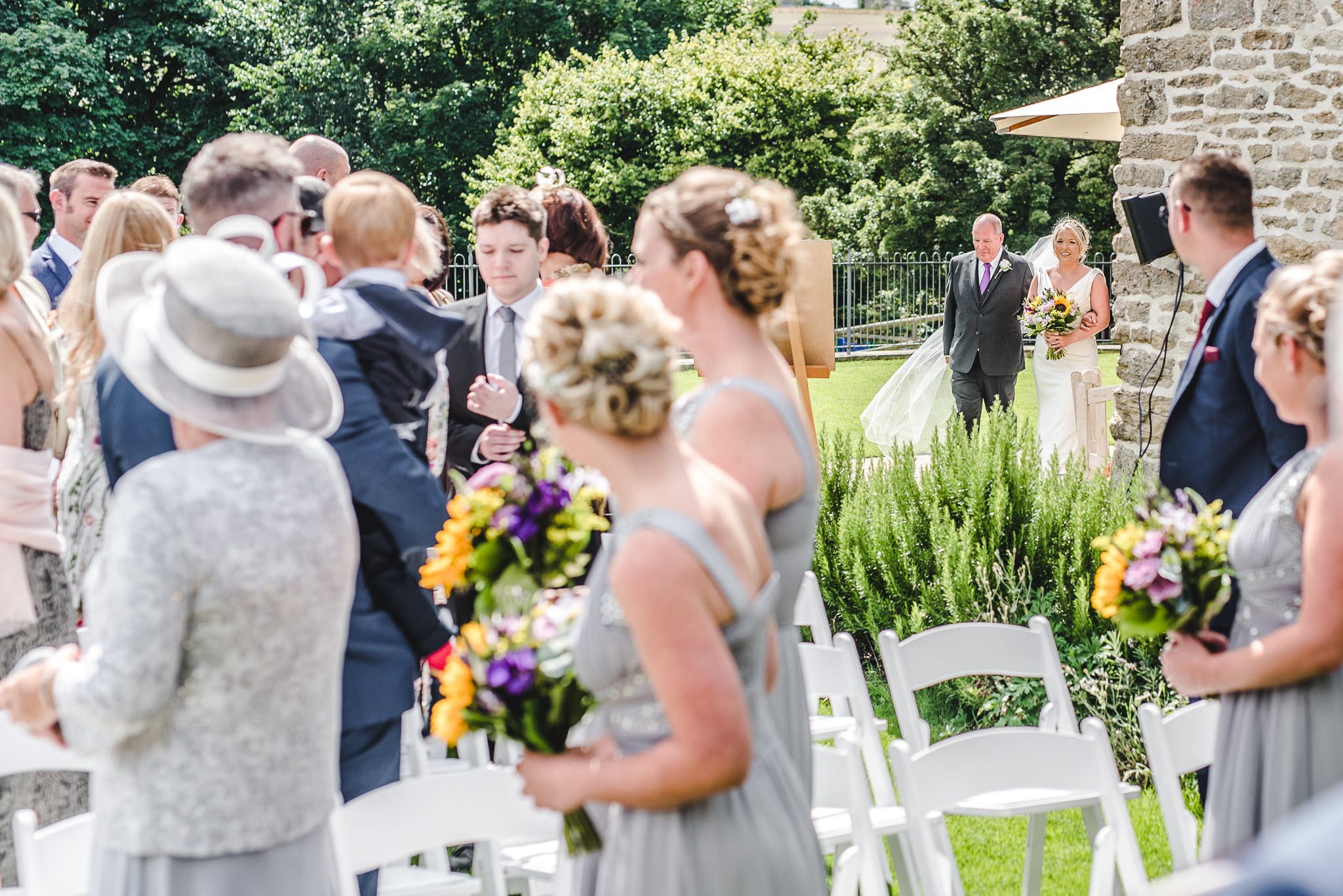 Bridesmaids at the top of an aisle