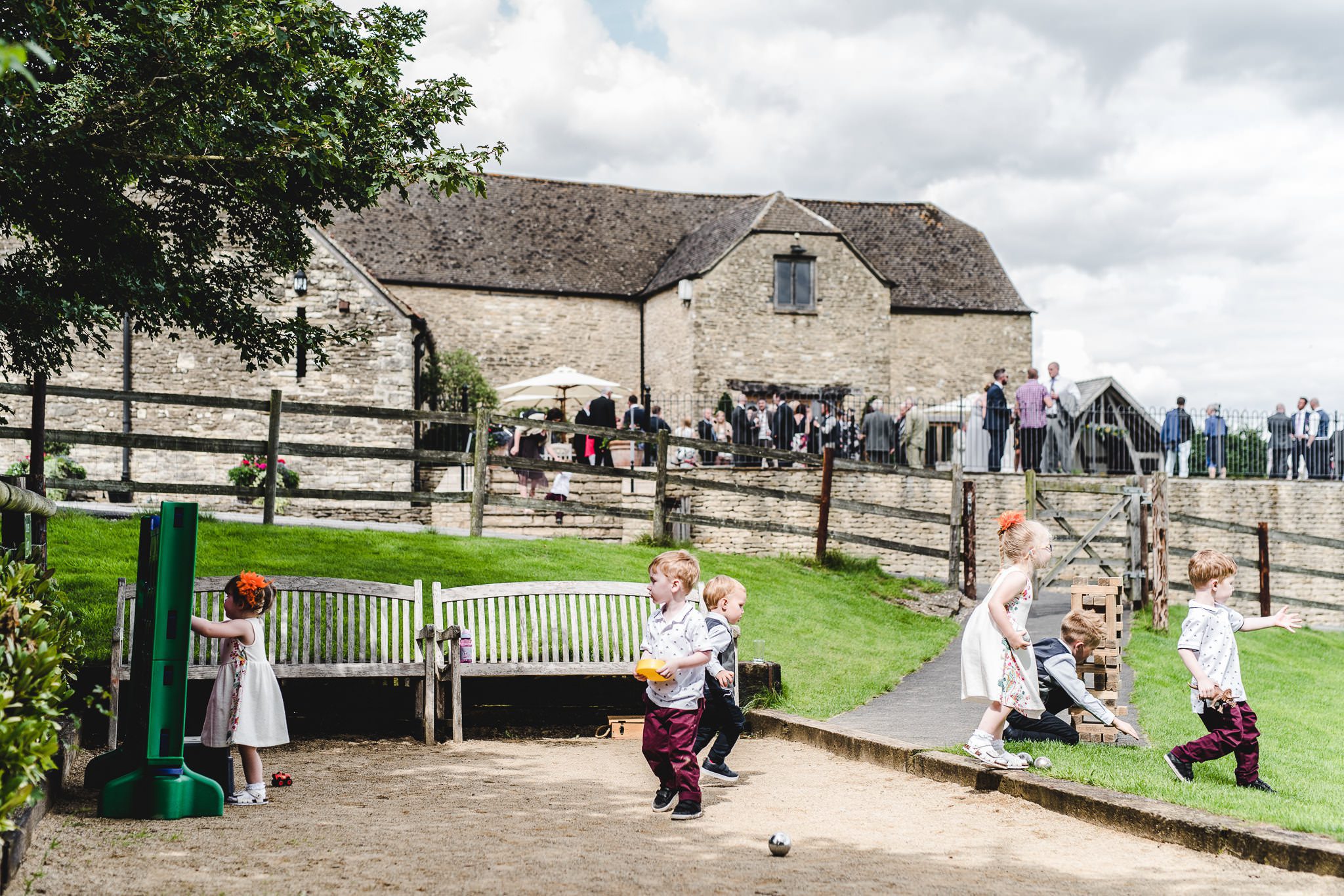 Kids playing in a boule pit at a wedding