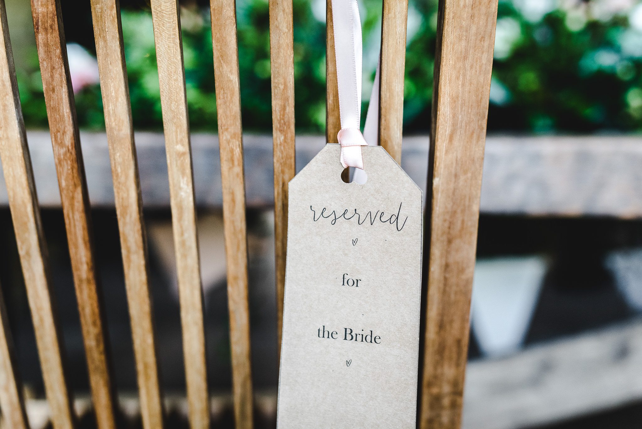 A reserved for the bride label on a chair