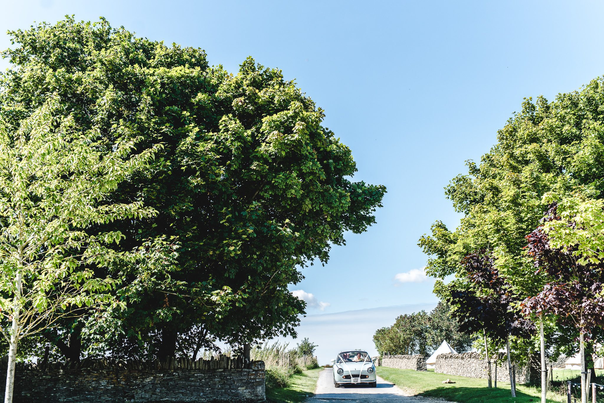 Bride arriving at Stone Barn in a Figaro wedding car