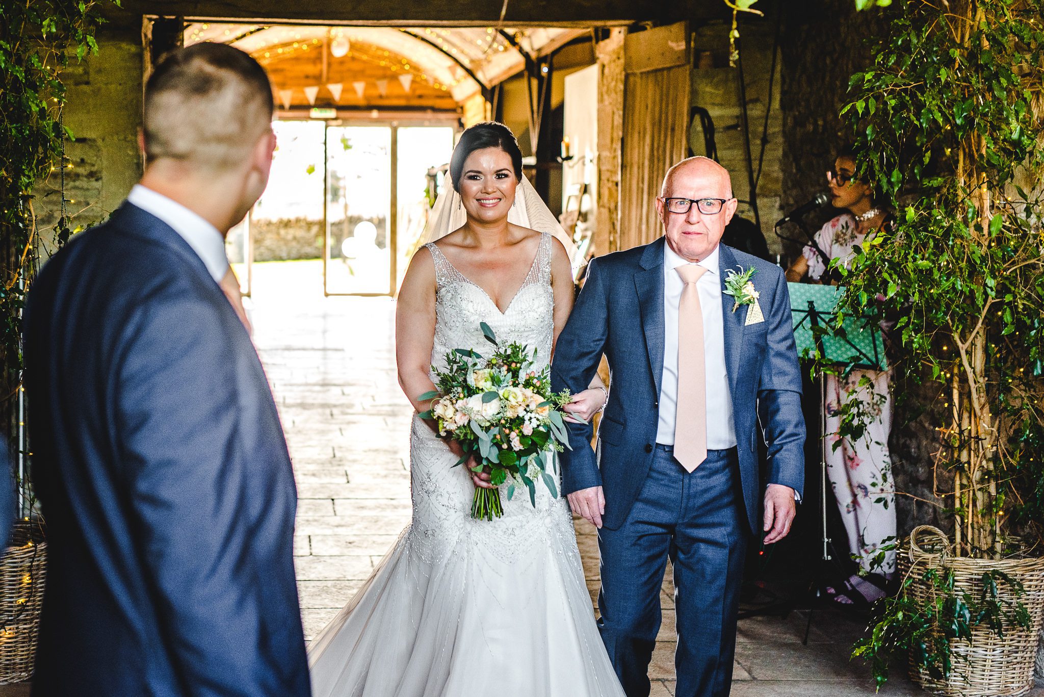 Bride walking down the aisle at Stone Barn