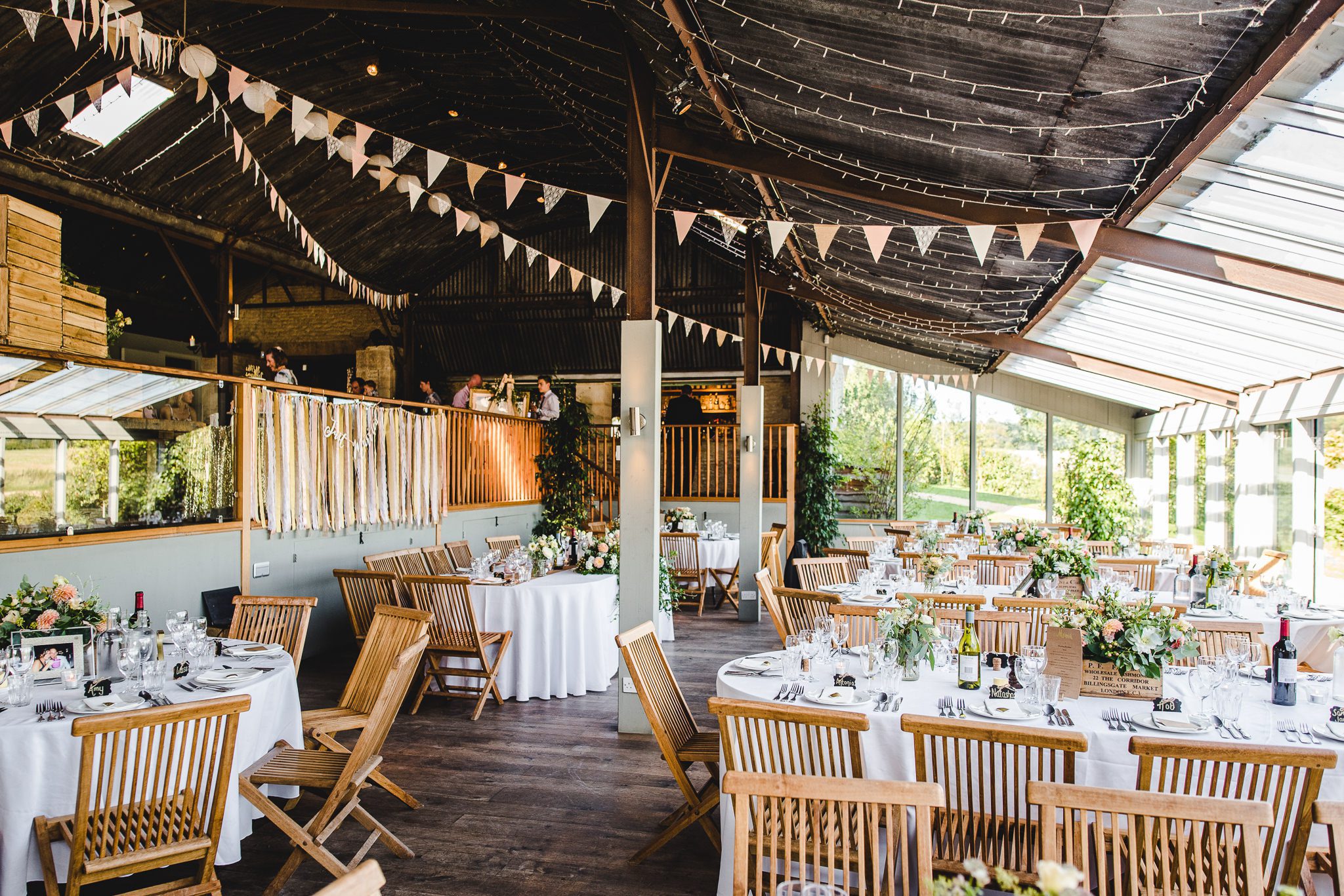 Wedding breakfast room set up at rustic wedding venue stone barn