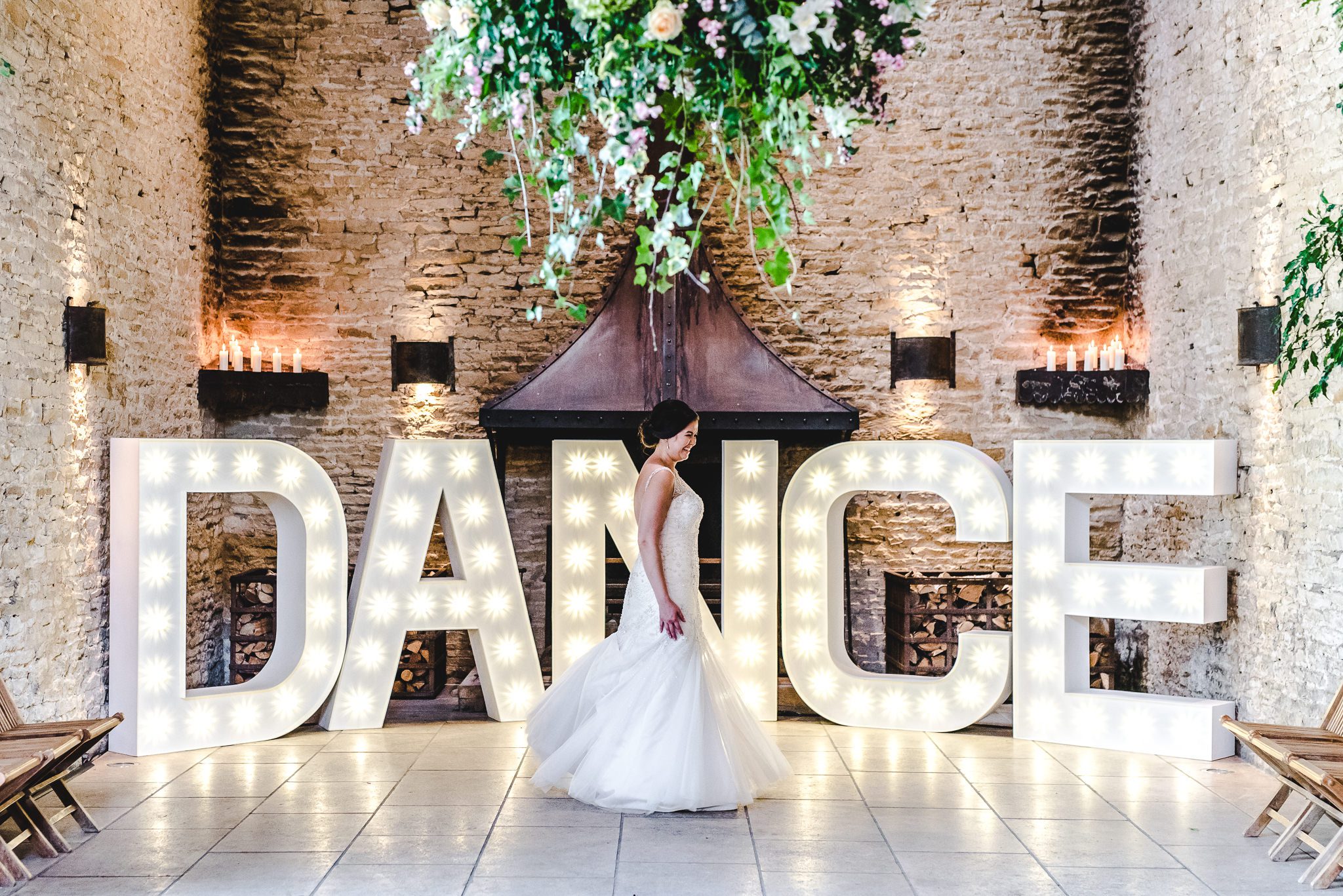 Bride dancing in front of large DANCE light up letters