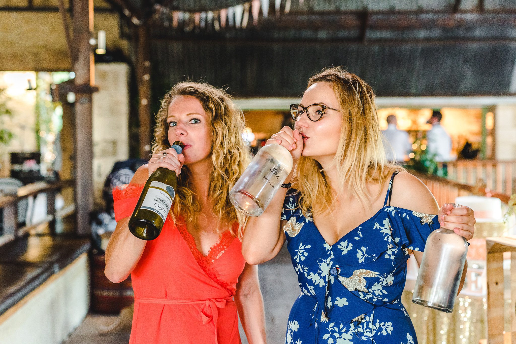 Wedding guests pretending to drink from wine bottles
