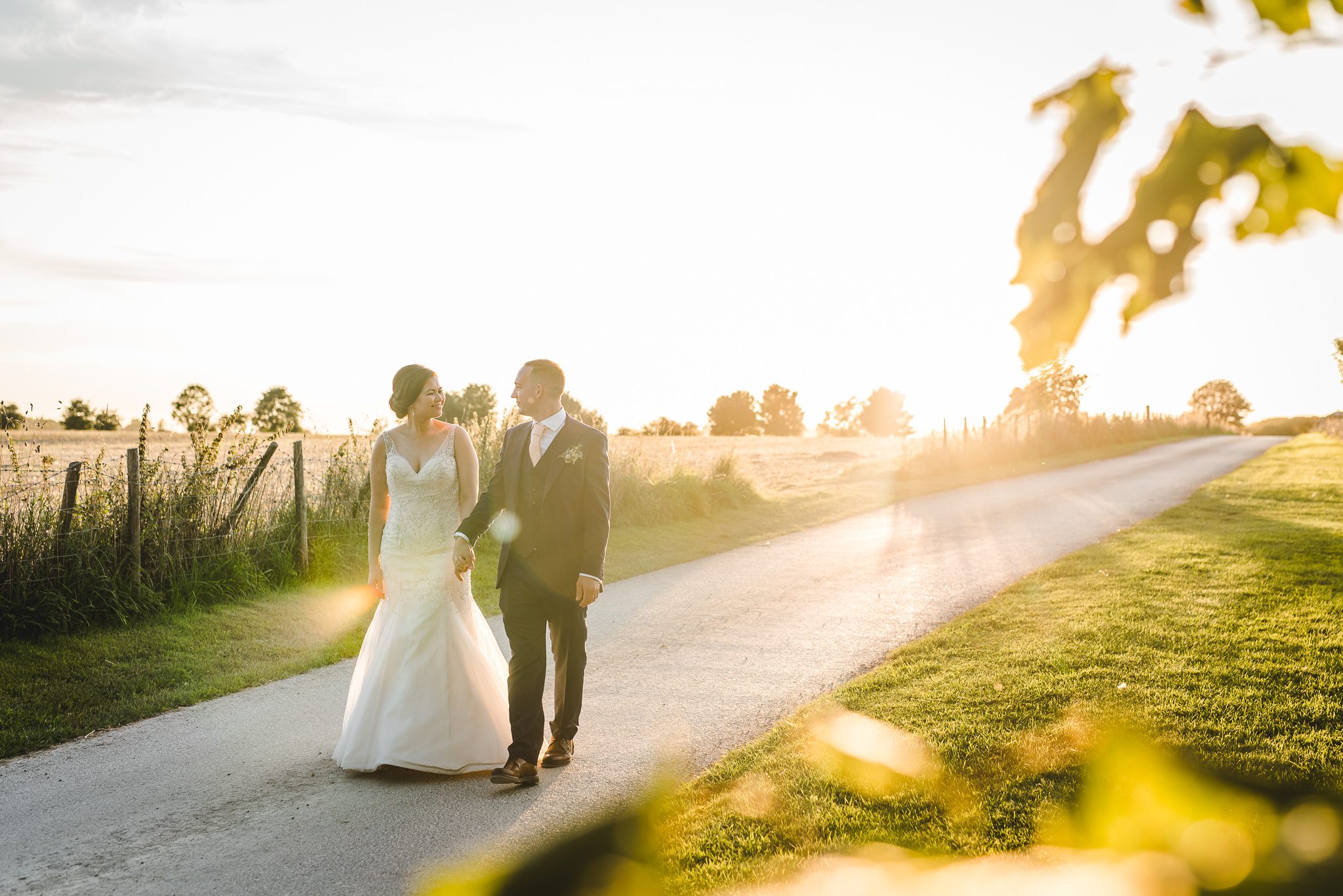 Bride and groom walking in the sunset