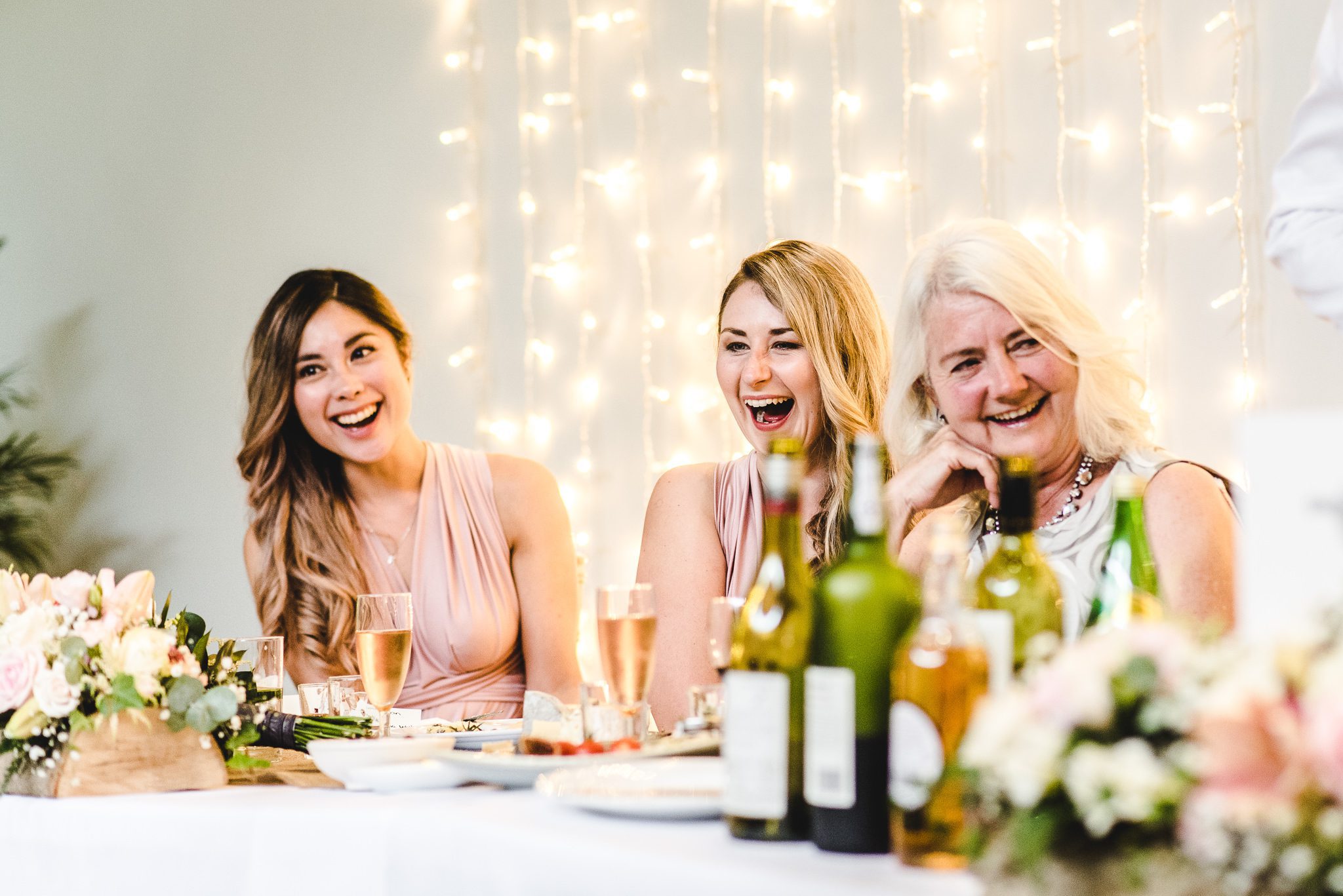 Guests laughing at funny wedding speeches