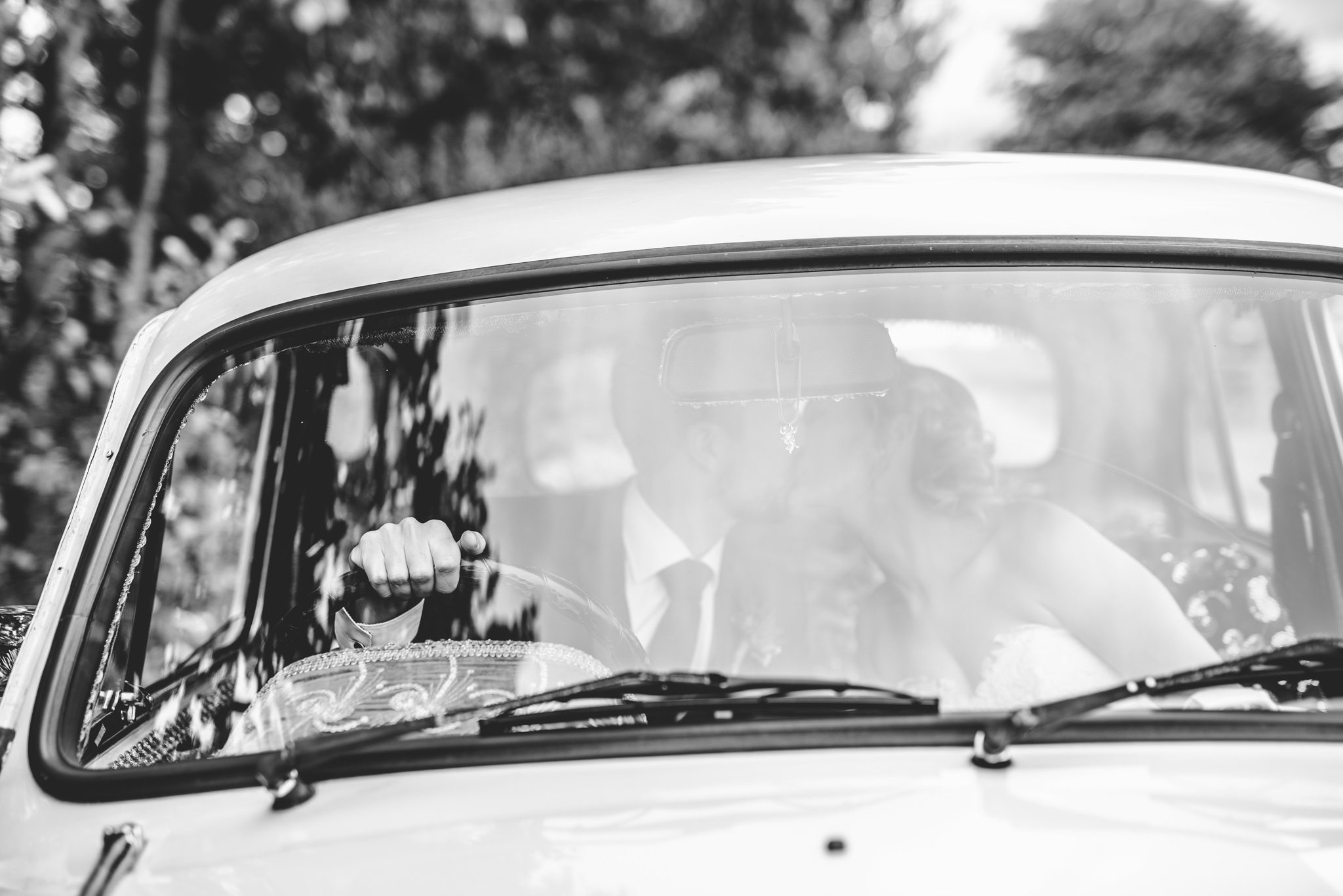 Abstract image of a bride and groom through the window of a Hindustan Ambassador