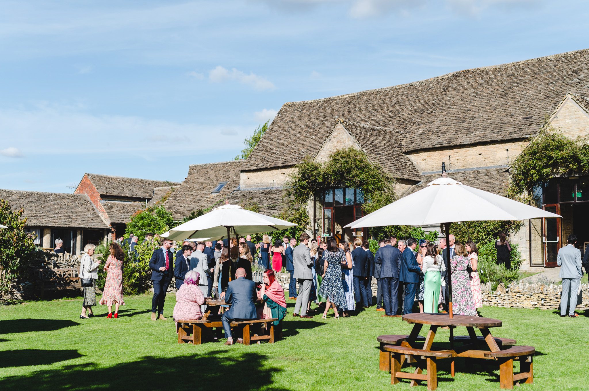 Wide view of a drinks reception at The Great Tythe Barn
