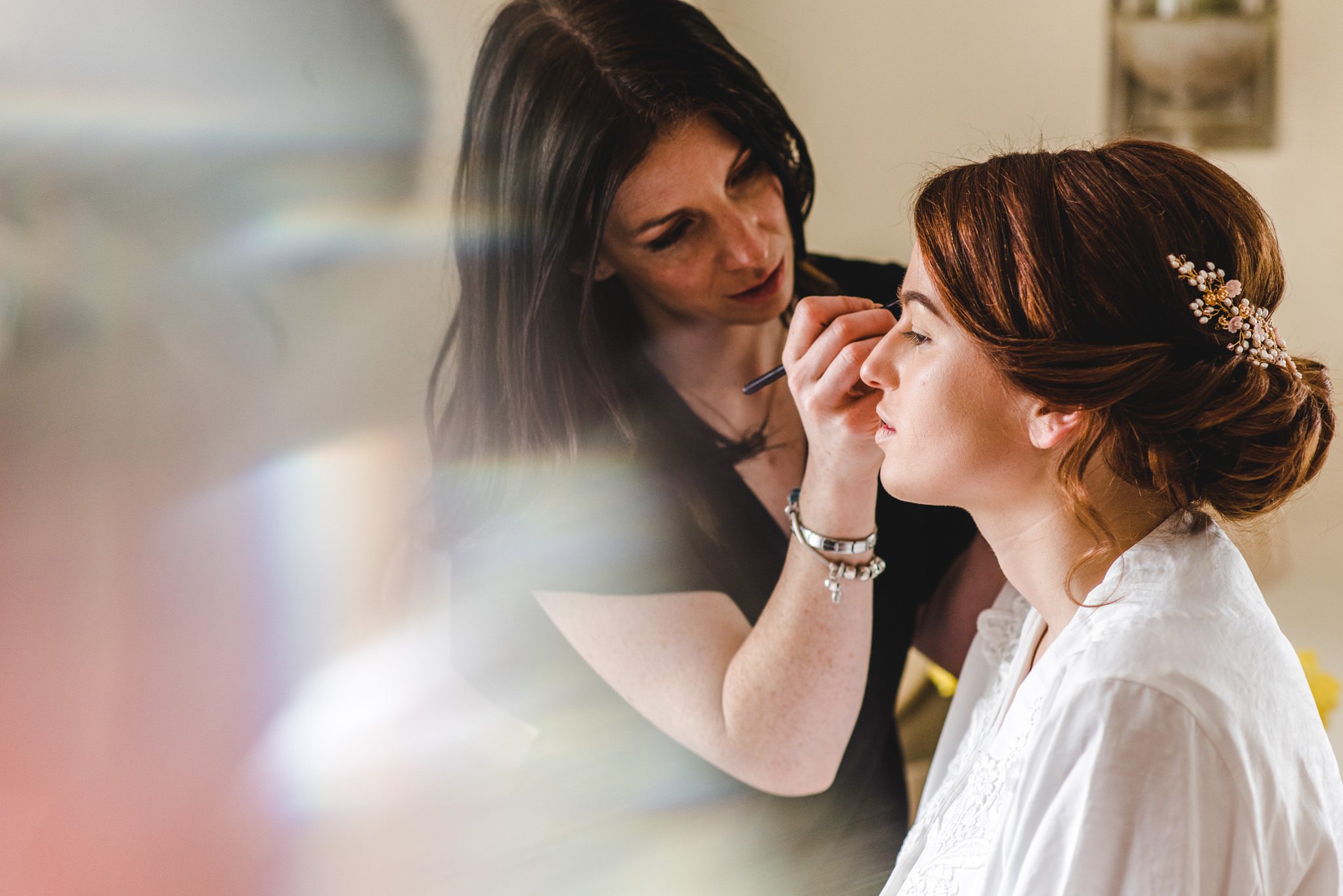 Katy Pheiffer wedding make up applying make up to her bride at the great tythe barn