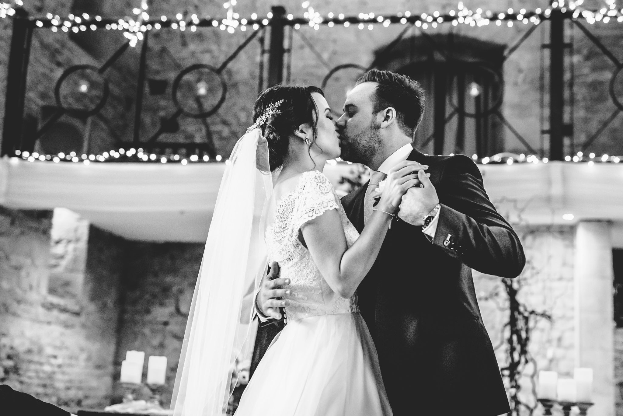 First kiss amongst the fairy lights at the great tythe barn