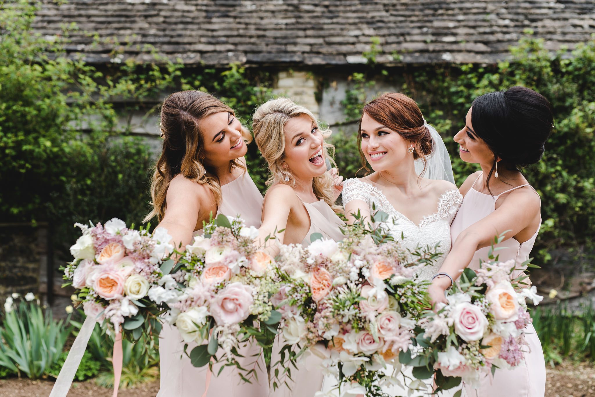 Bridesmaids with bouquets at the great tythe barn
