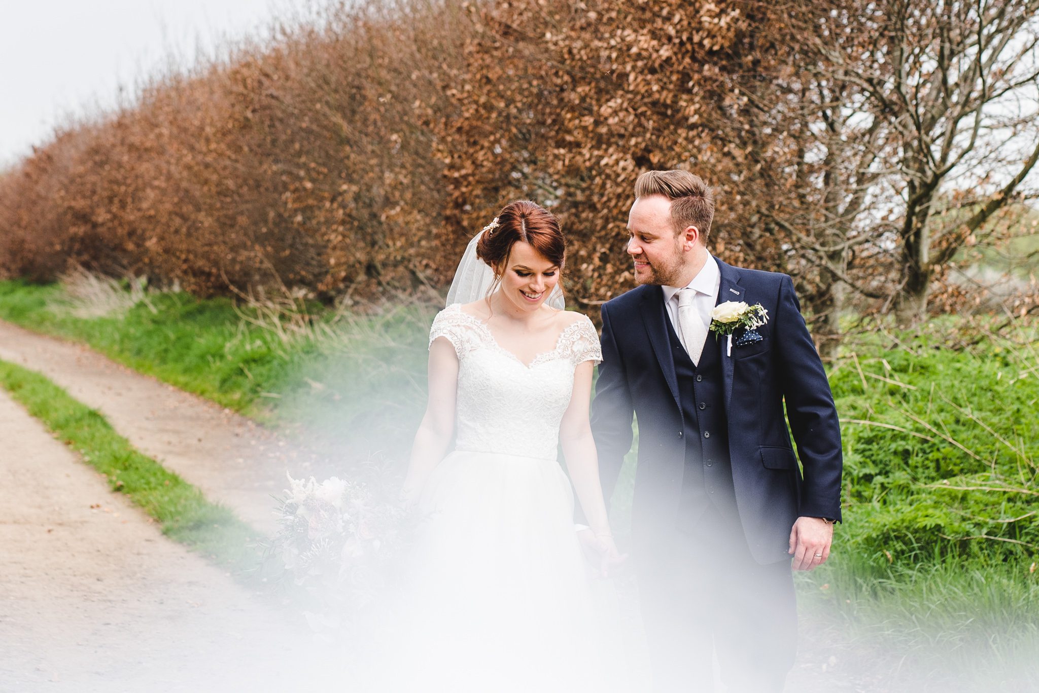 A newly married couple walking in Tetbury