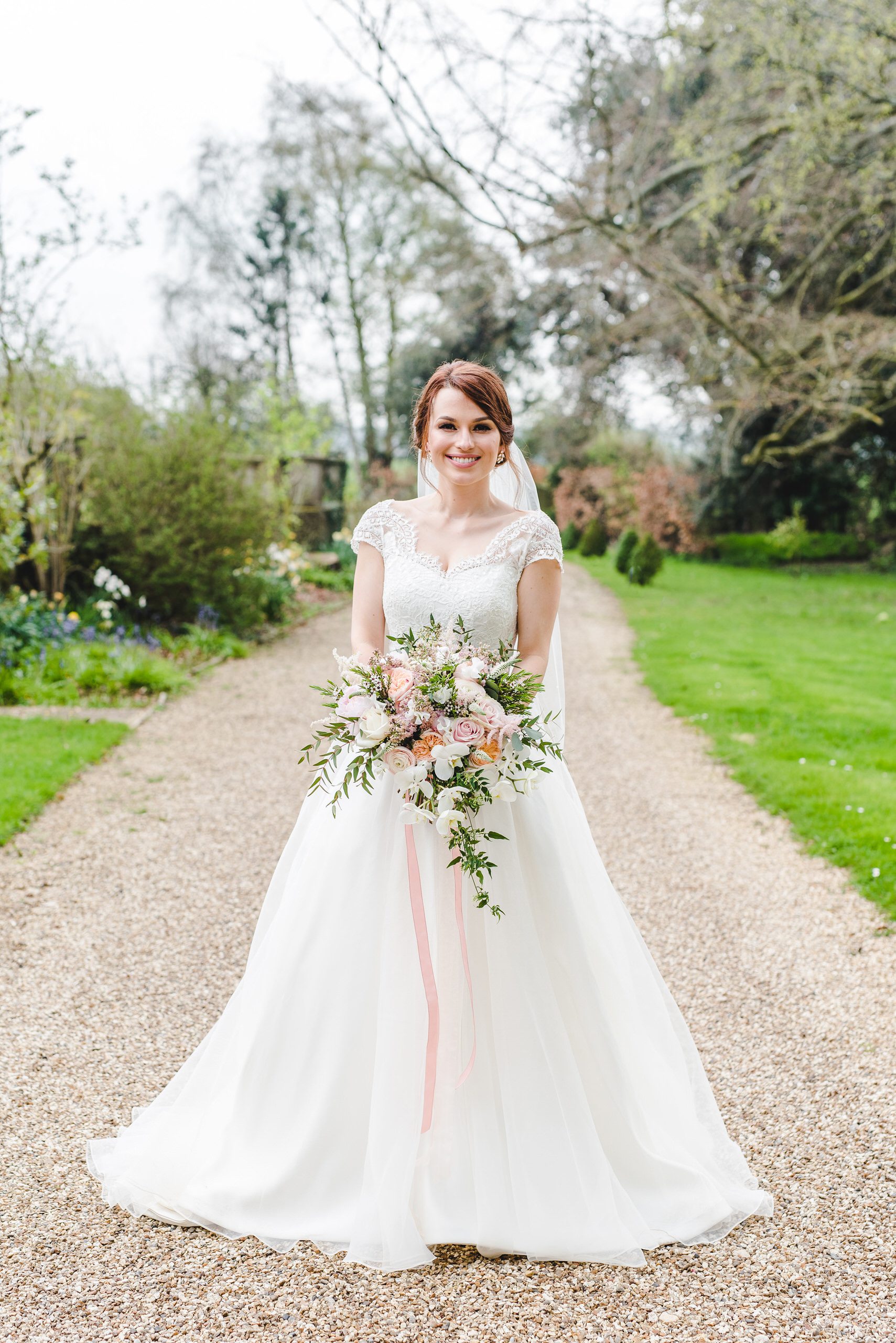 A beautiful bride with Acacia floristry flowers at the great tythe barn