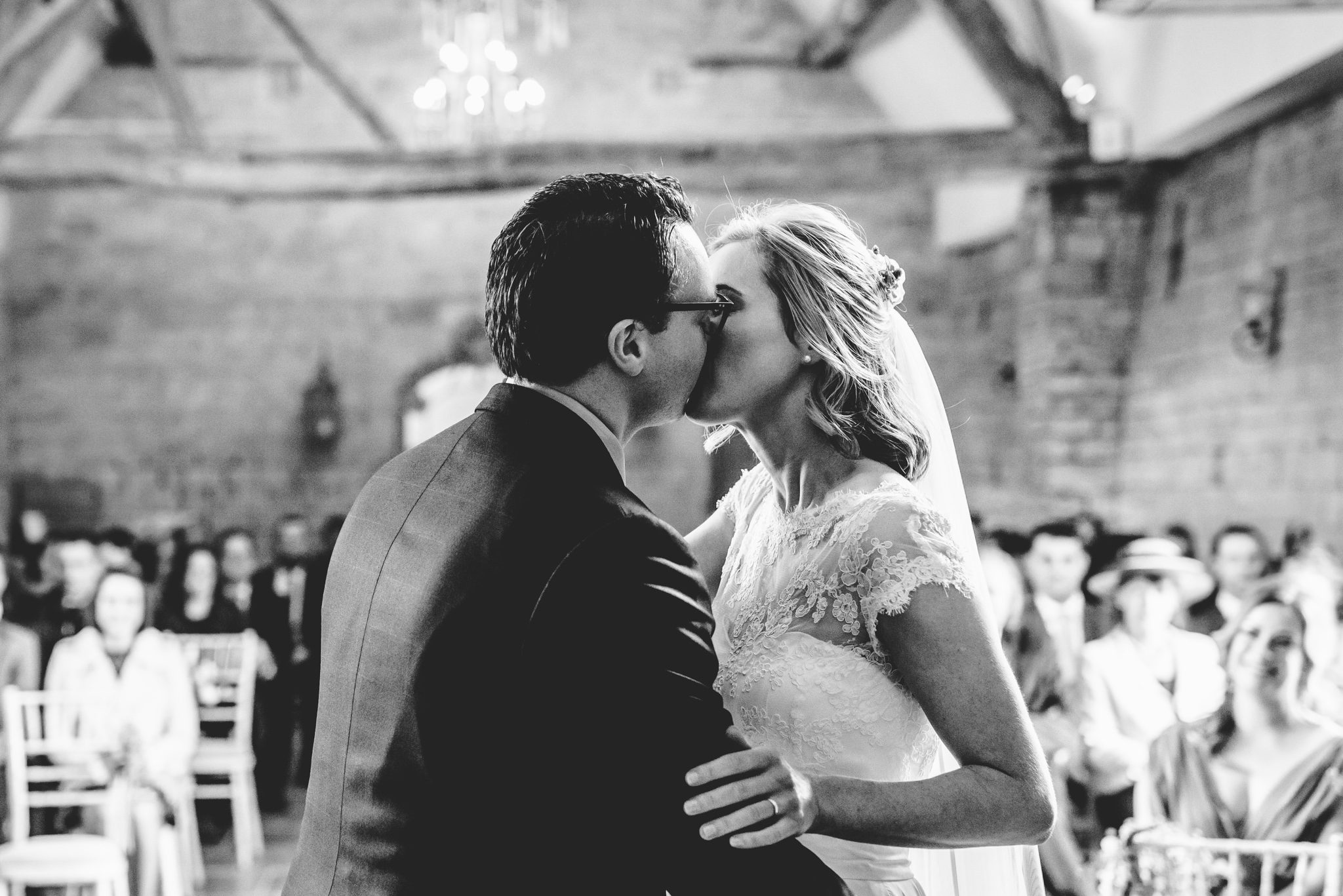 Bride kissing groom in black and white at blackwell grange