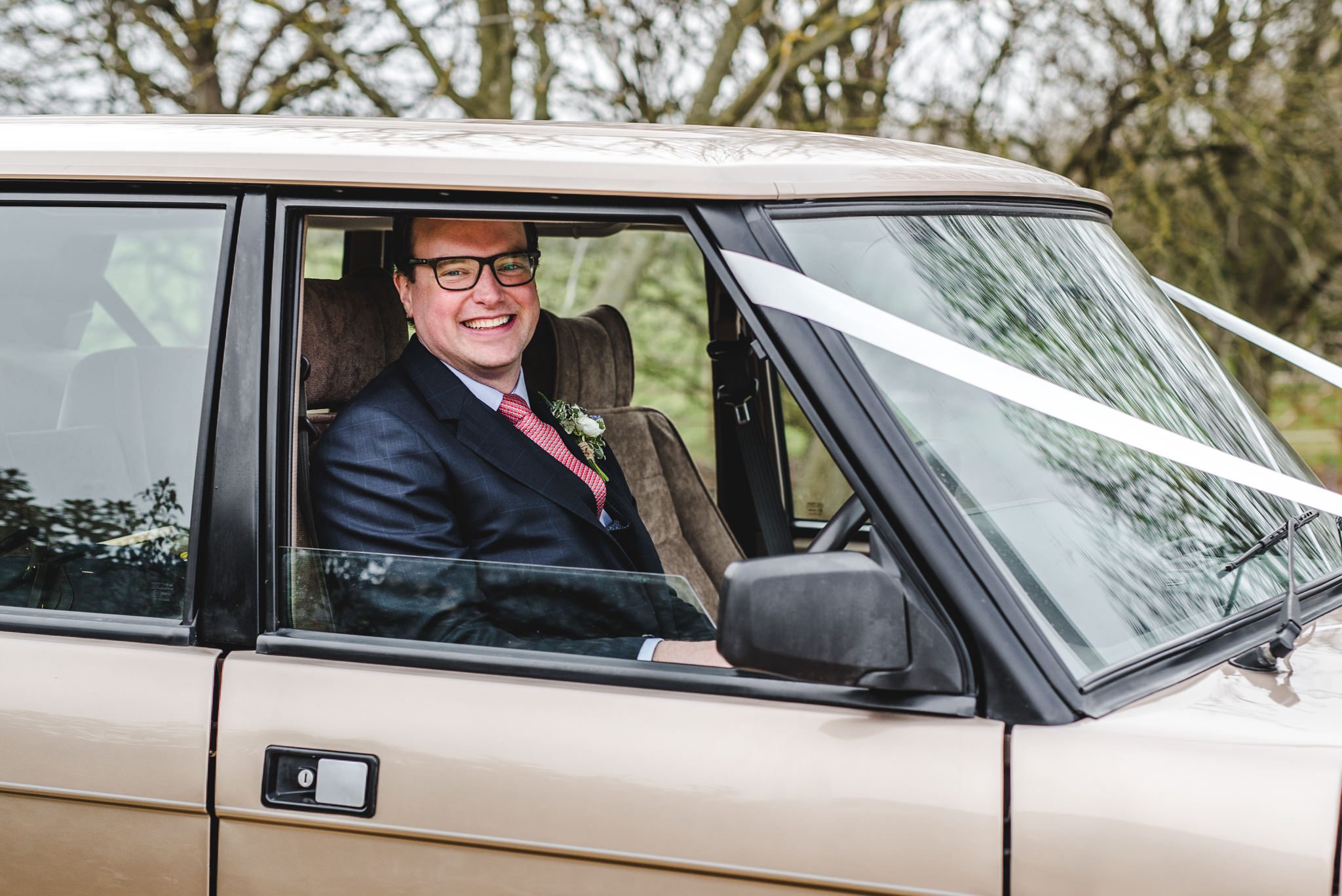 Groom sat in his range rover