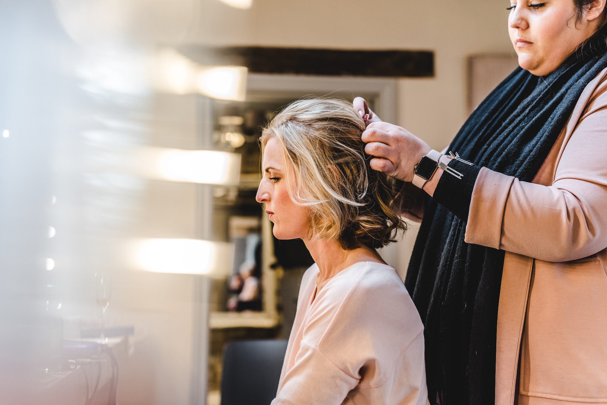 Bride having hair tied up at Blackwell Grange wedding venue