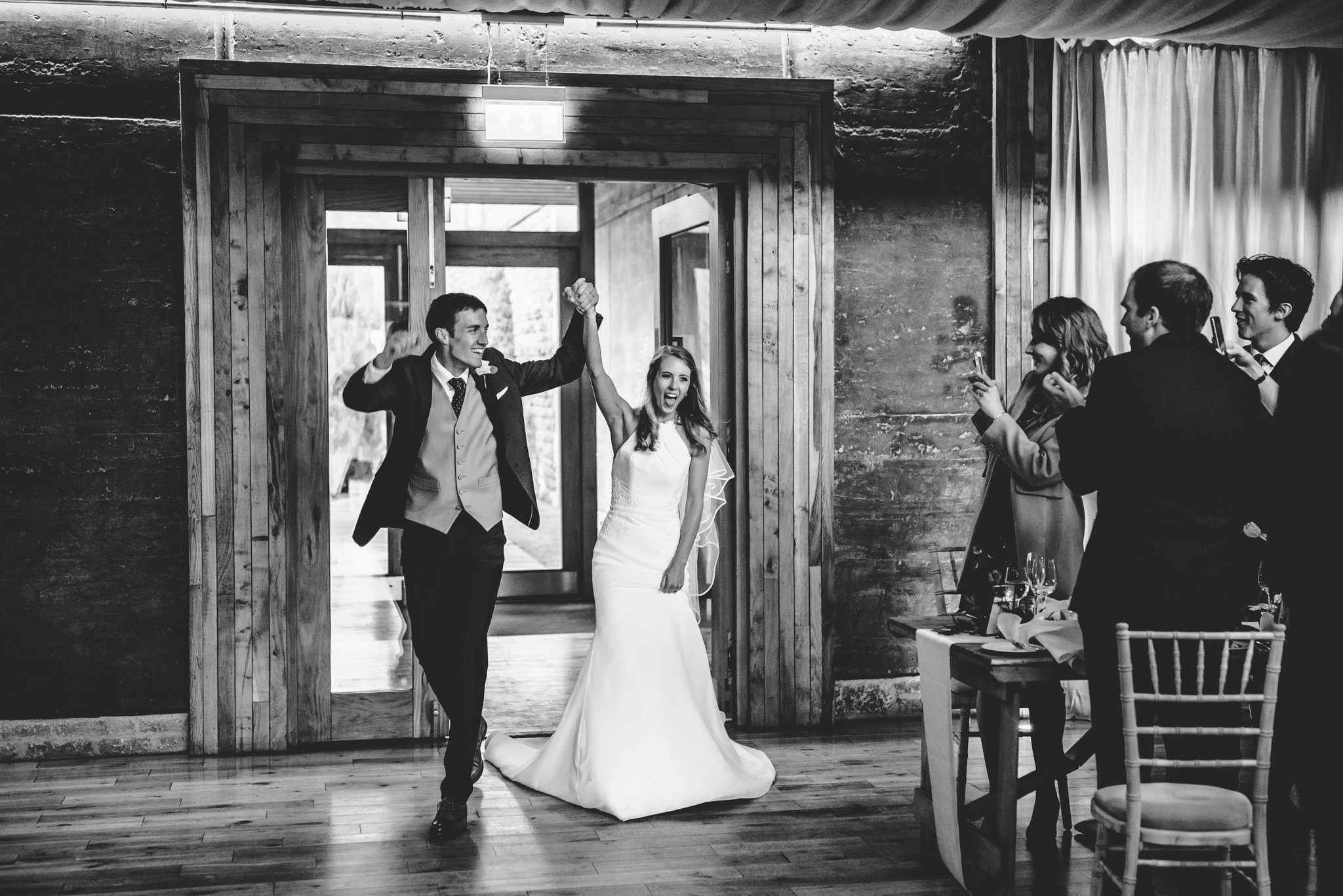 Bride and Groom entering their wedding breakfast at Elmore Court