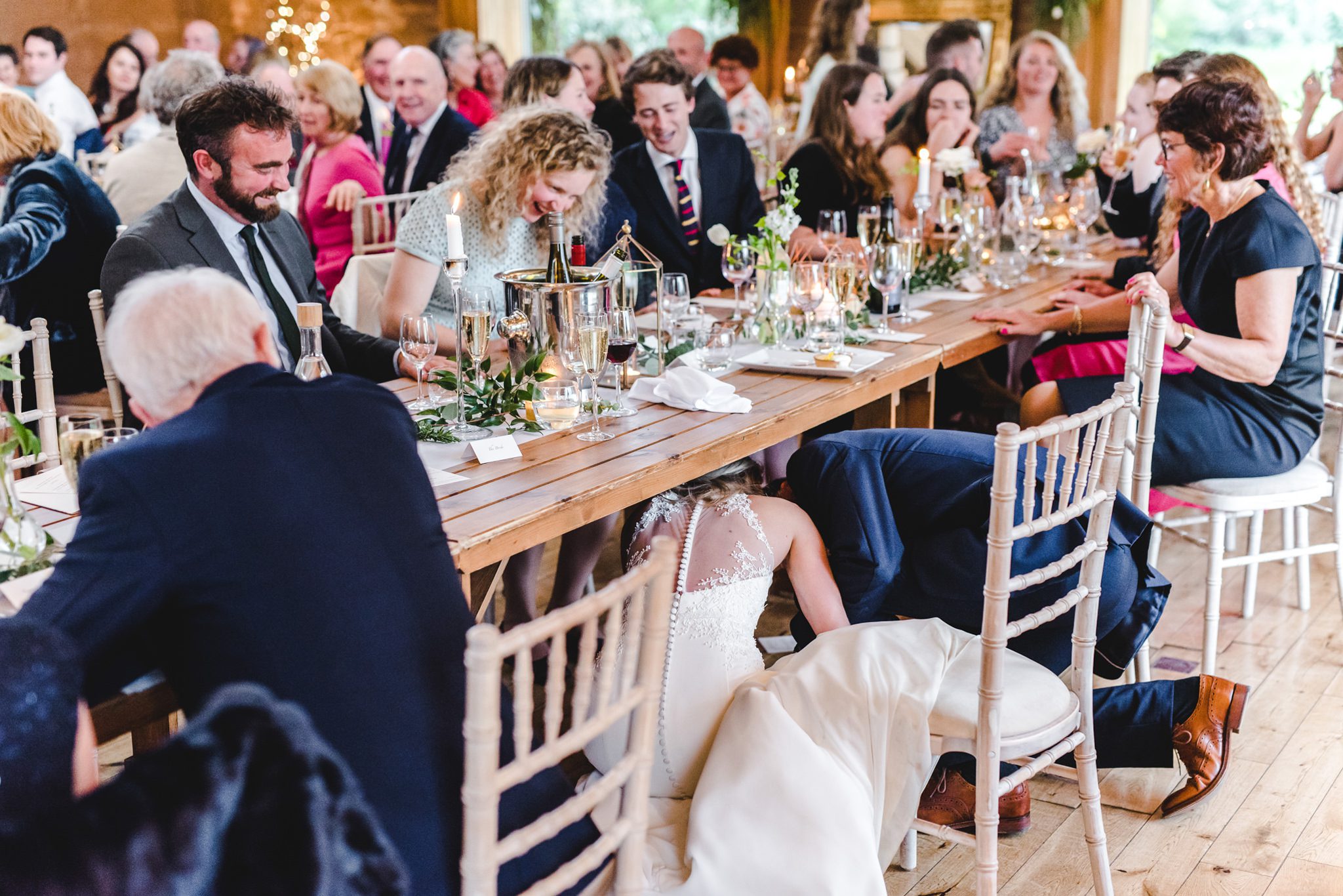 Danish wedding tradition of kissing under the table - Bigeye Photography