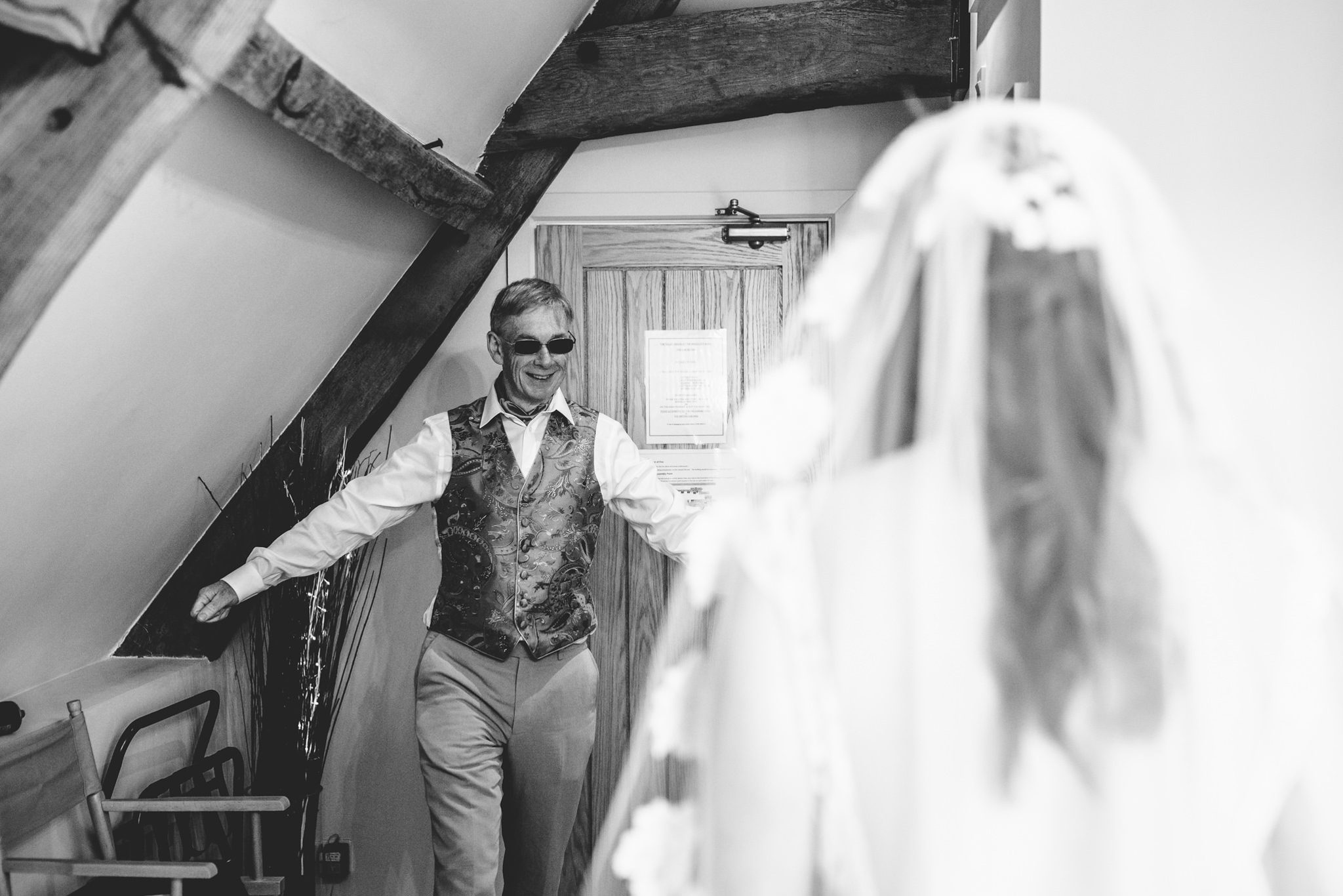 Father of the bride greeting his daughter in her wedding dress