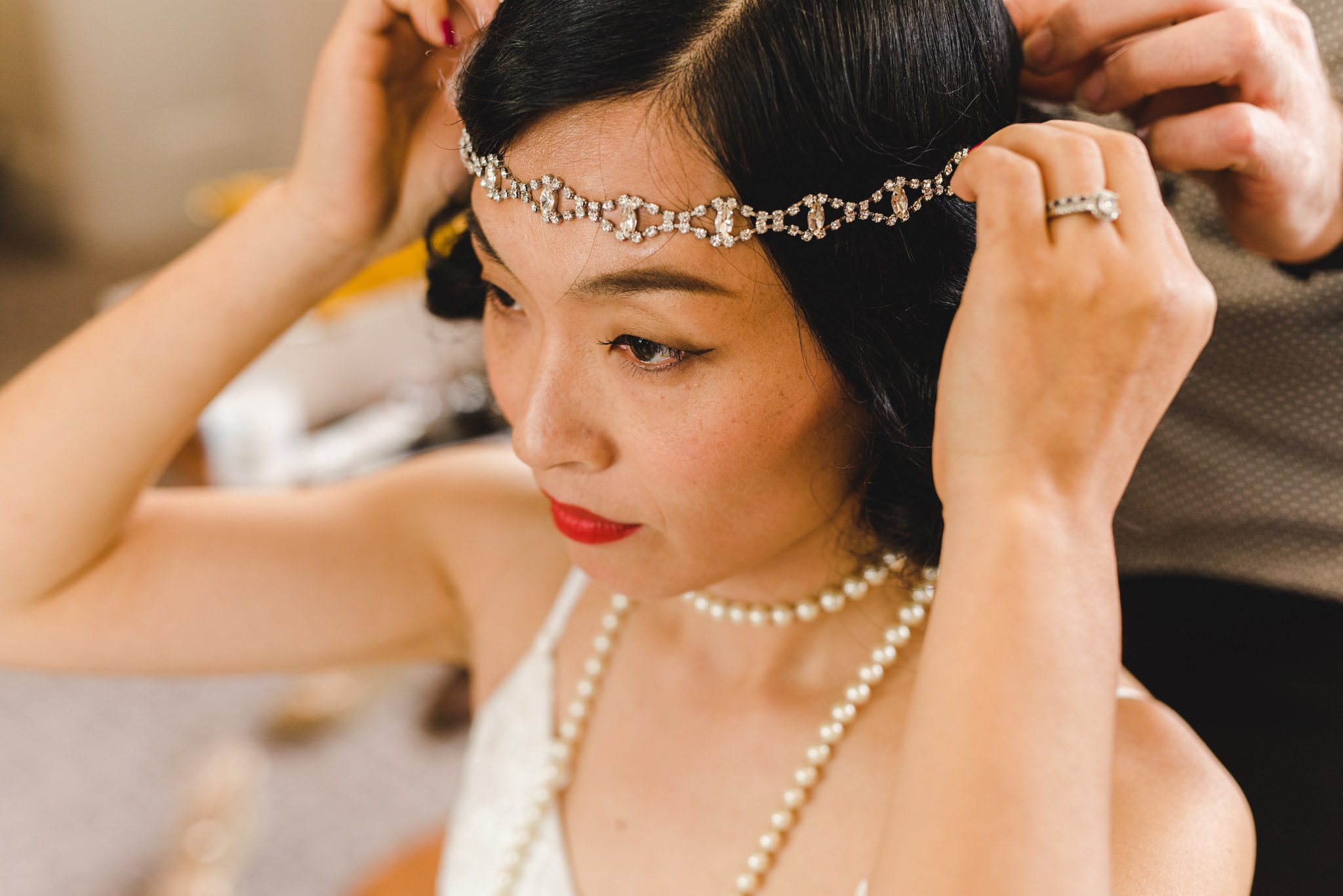 Chinese bride putting on her tiara