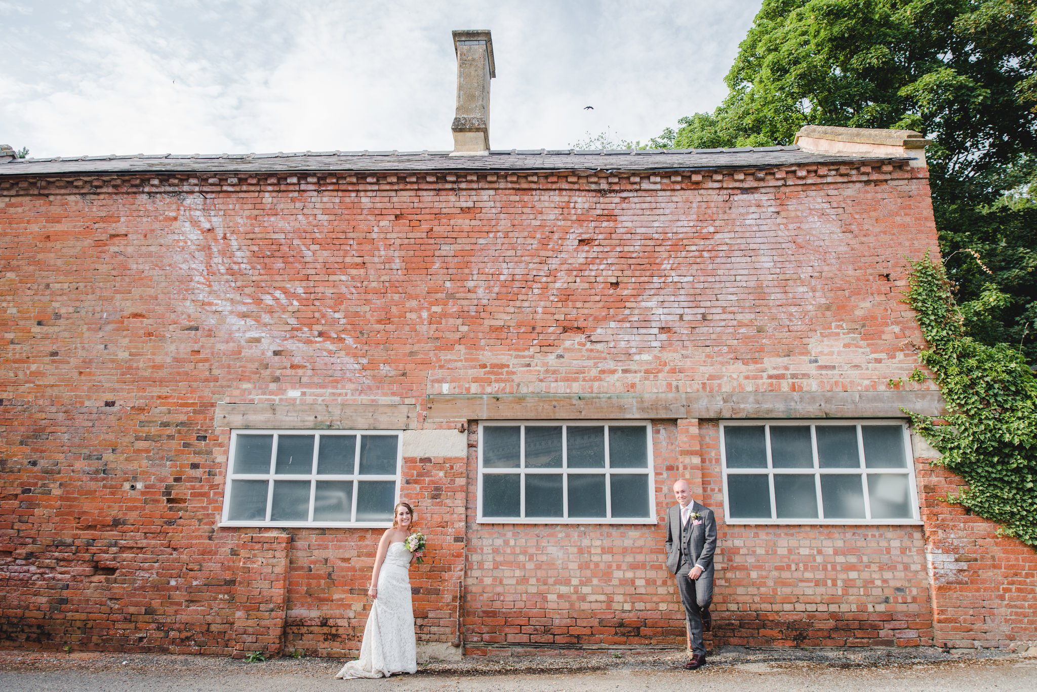 Bride and groom against an old brick wall
