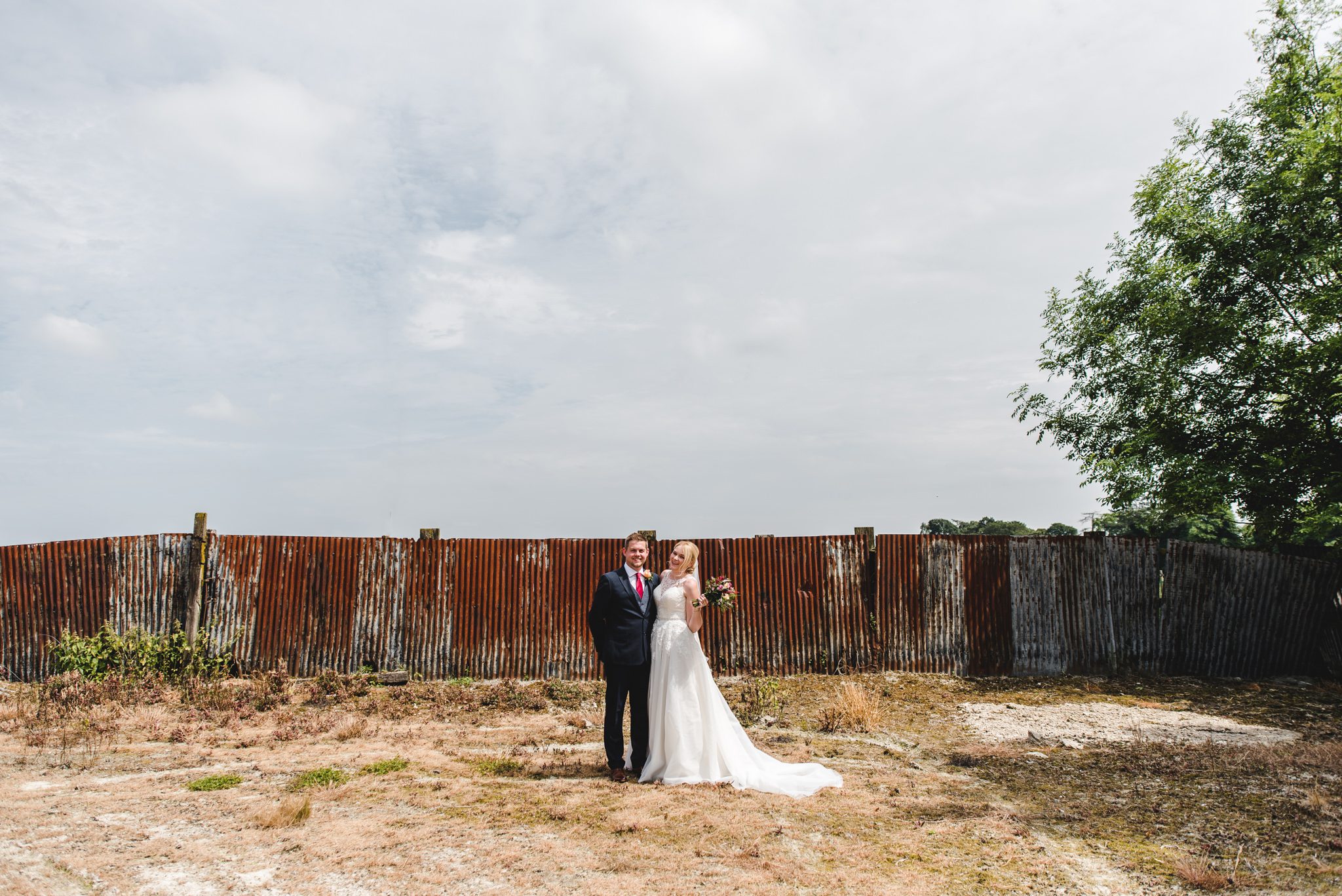 Bride and groom posing at Cold Harbour Barn