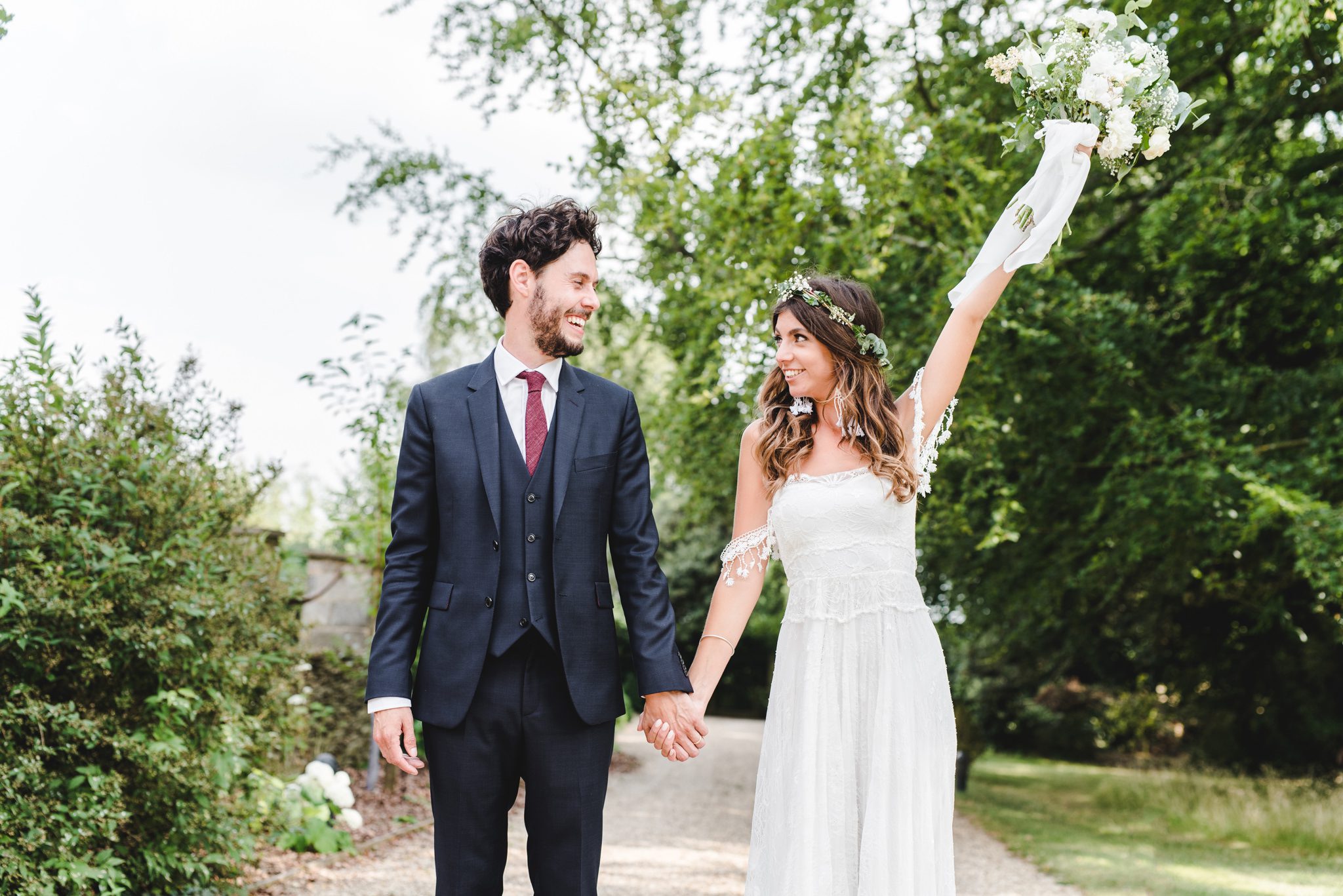 Bride holding her bouquet in the air