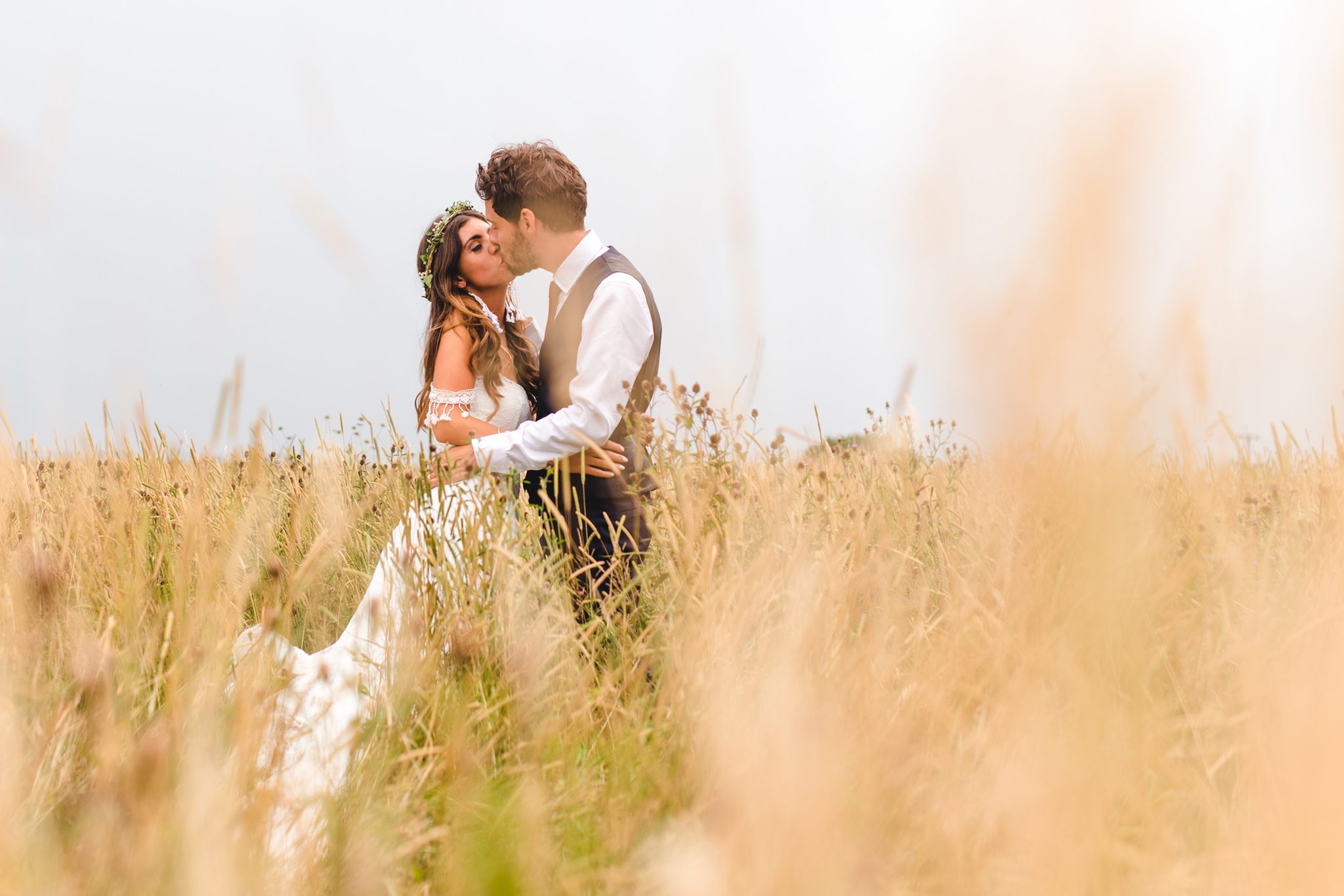 Couple in a yellow field hugging in Gloucestershire