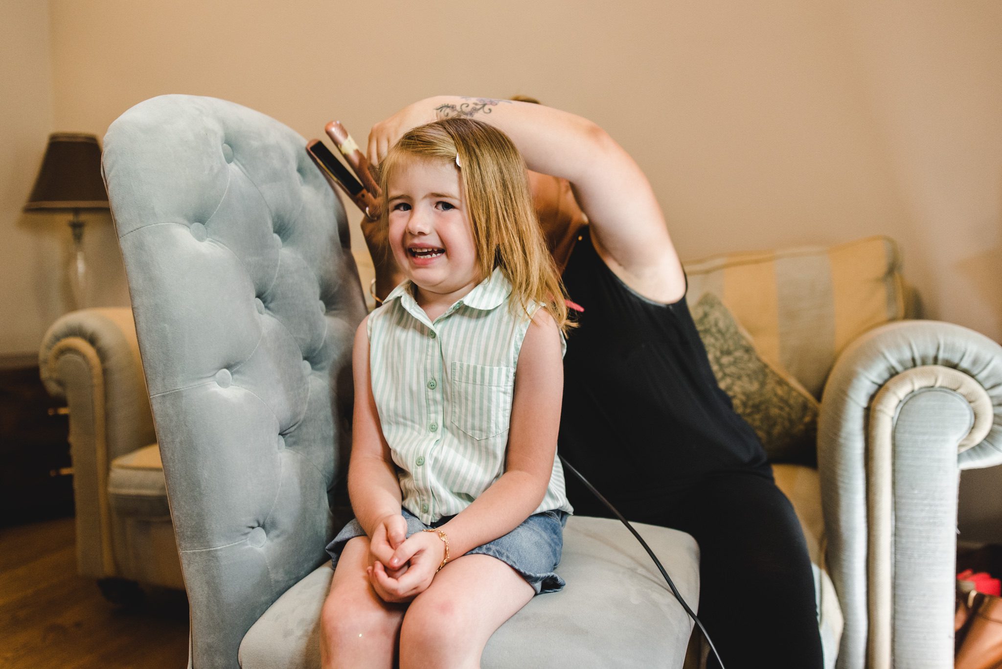 flower girl having her hair styled