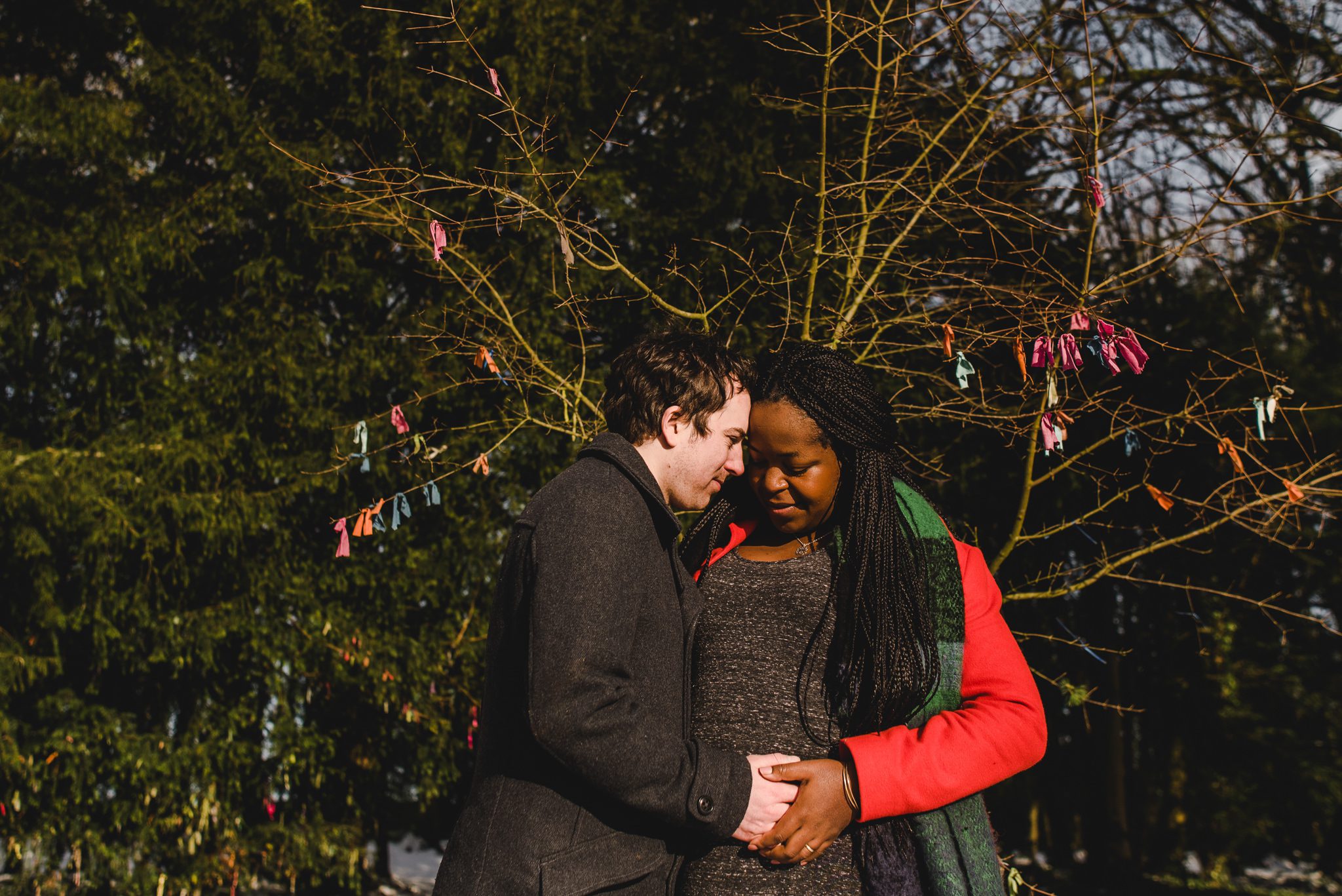 Winter sun shining on a couple who are having a baby