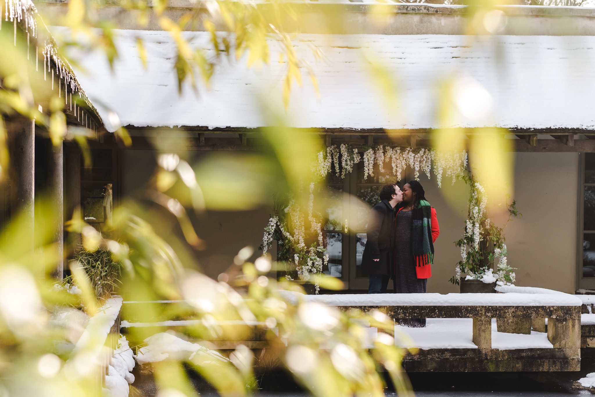 A couple kissing in teh ceremony area at Matara