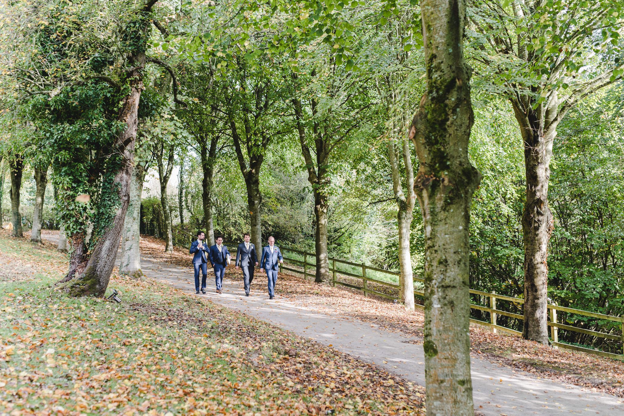 Groom and his boys walking along the path at Owlpen towards his wedding venue