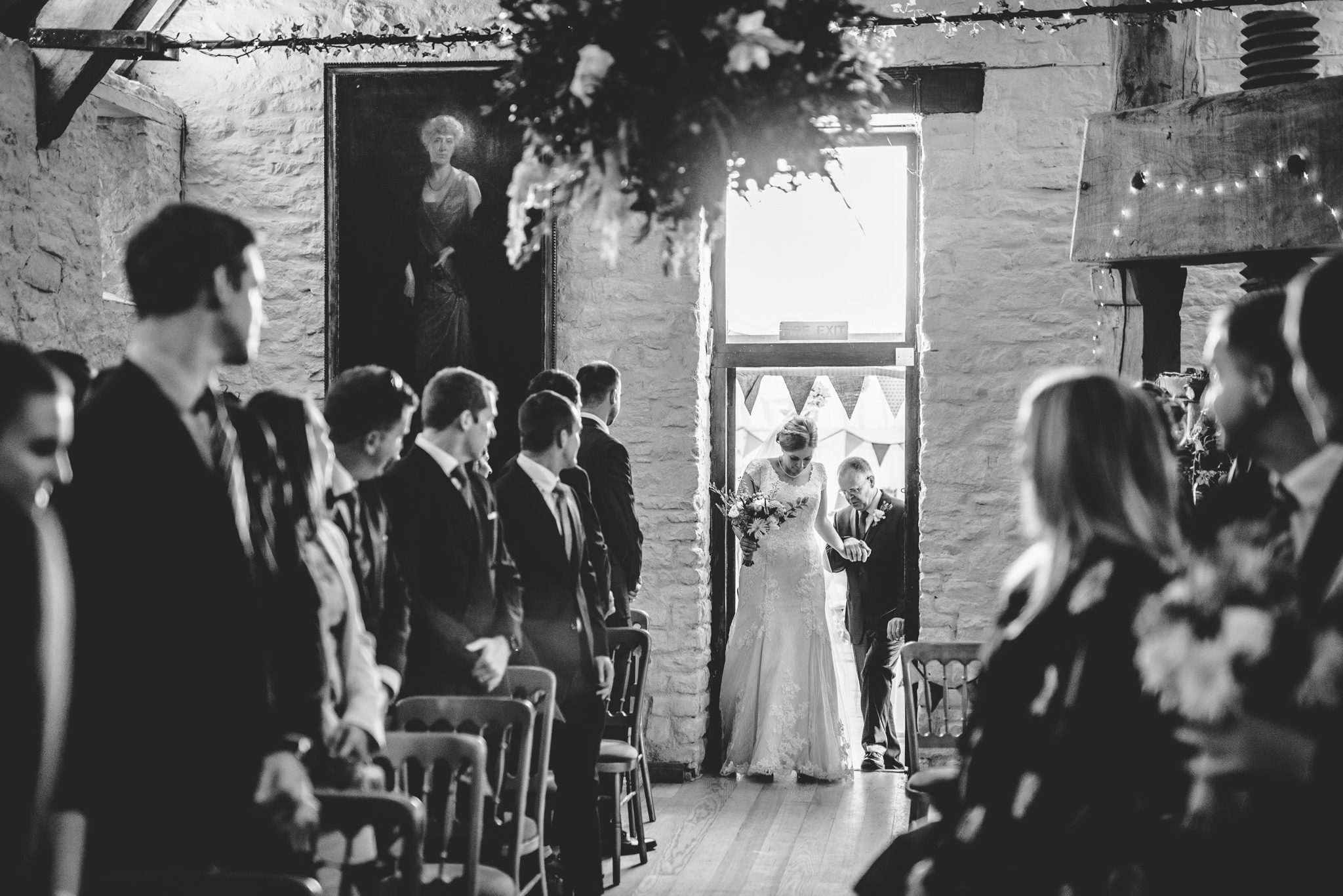 A bride entering the cyder barn with her father at Owlpen