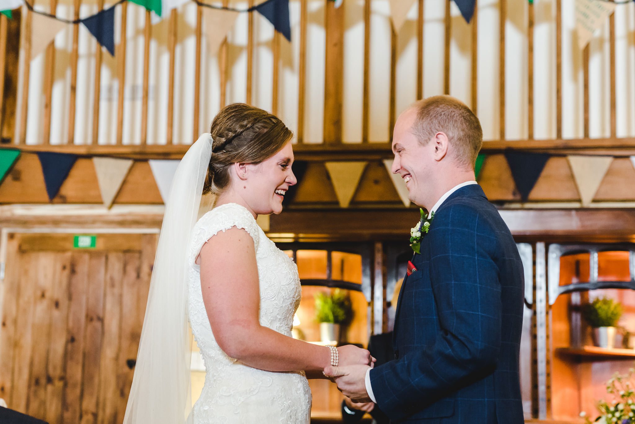 A bride and groom exchanging smiles and tears during their Owlpen Manor wedding ceremony