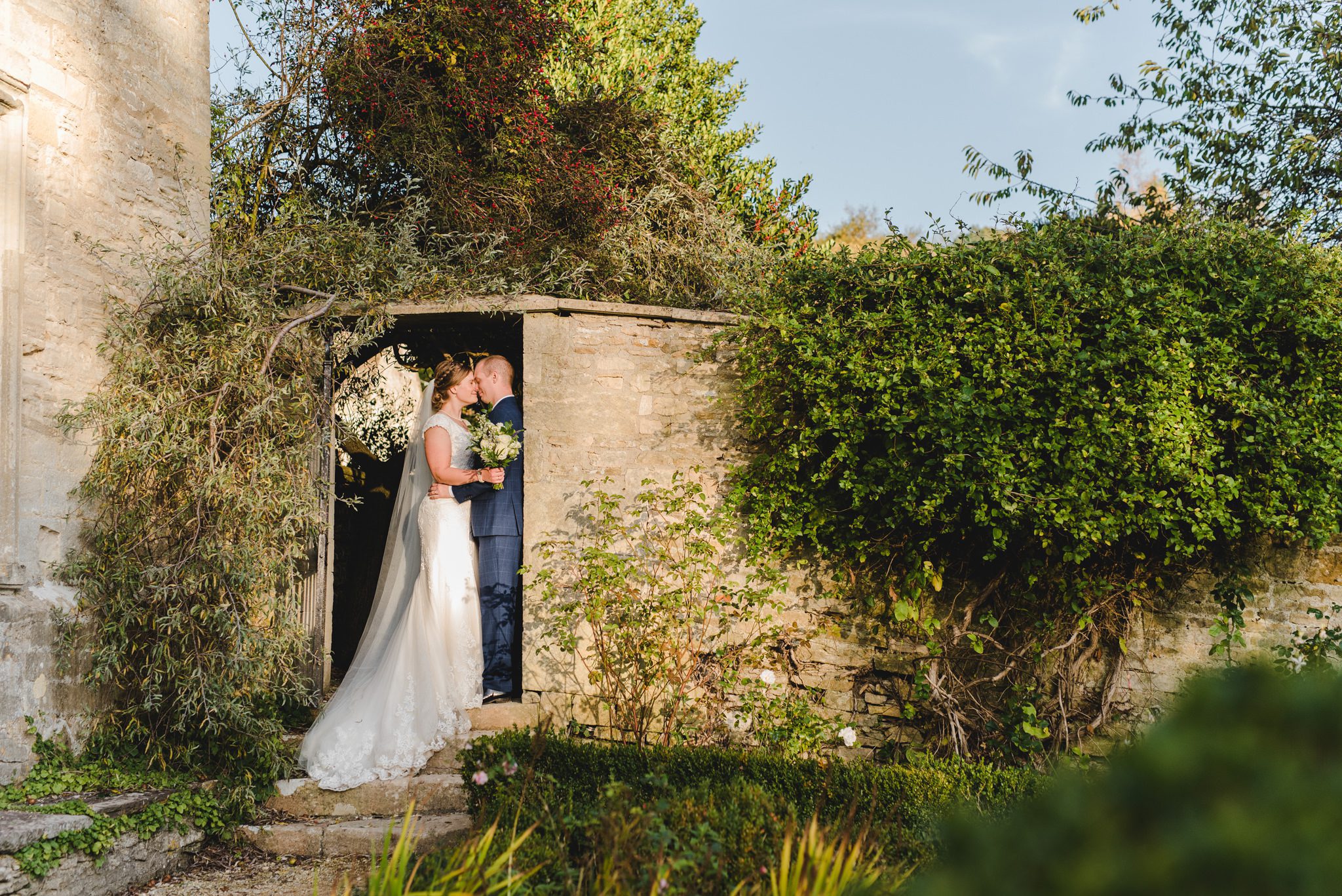 A couple standing in beautiful light at Owlpen Manor