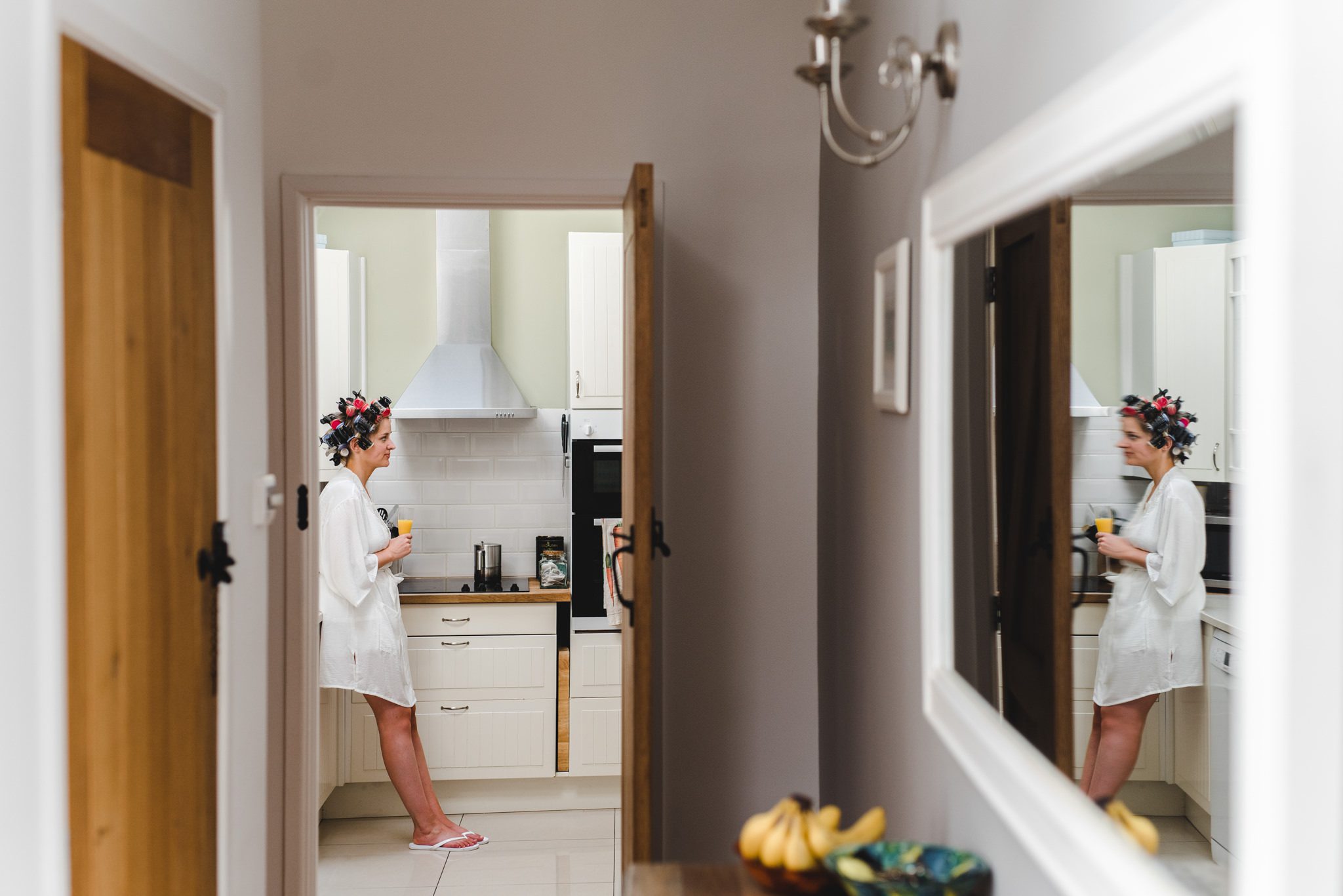 A bride reflected in a mirror ahead of her wedding