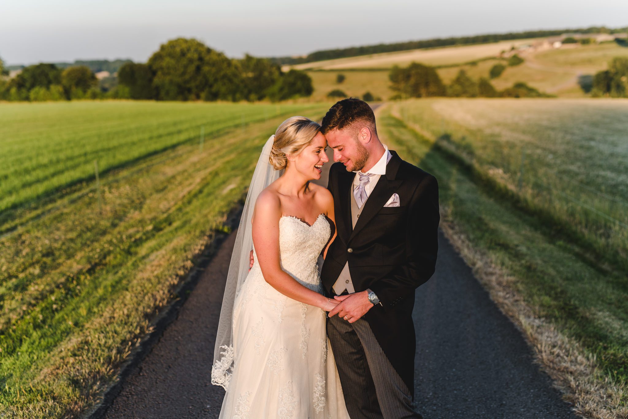 A bride and groom standing in nice light at Kingscote Barn