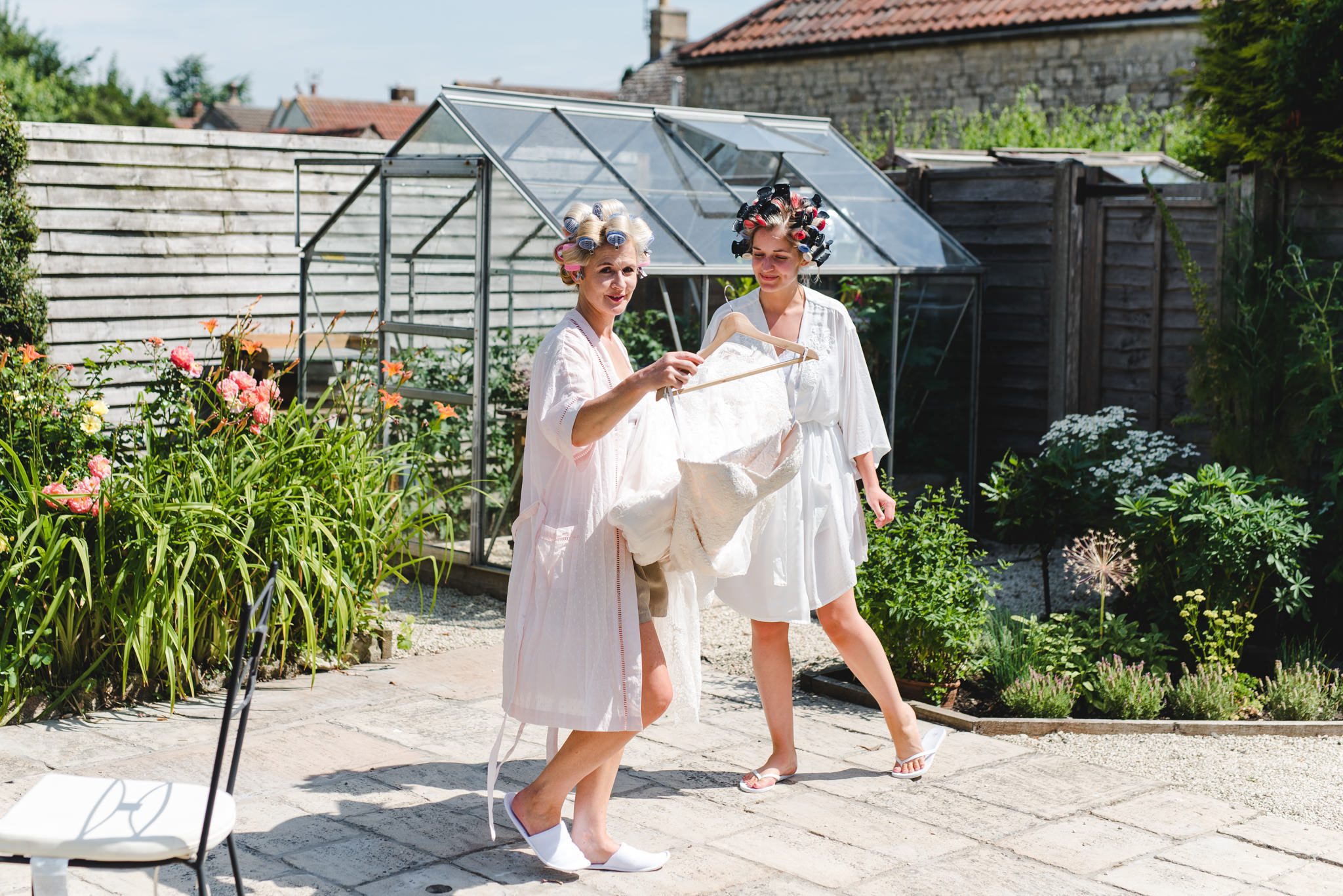 mum and bride carrying weding dress