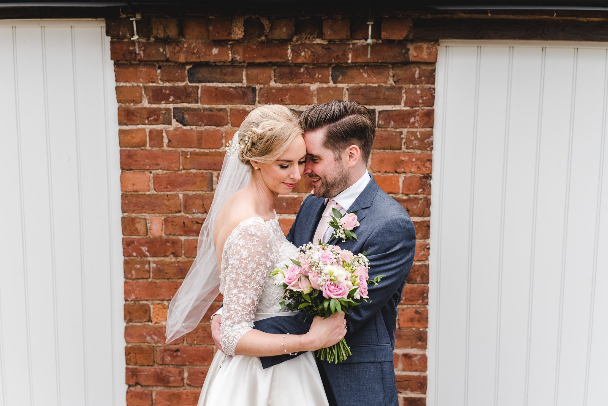 A bride with her bouquet close to her groom