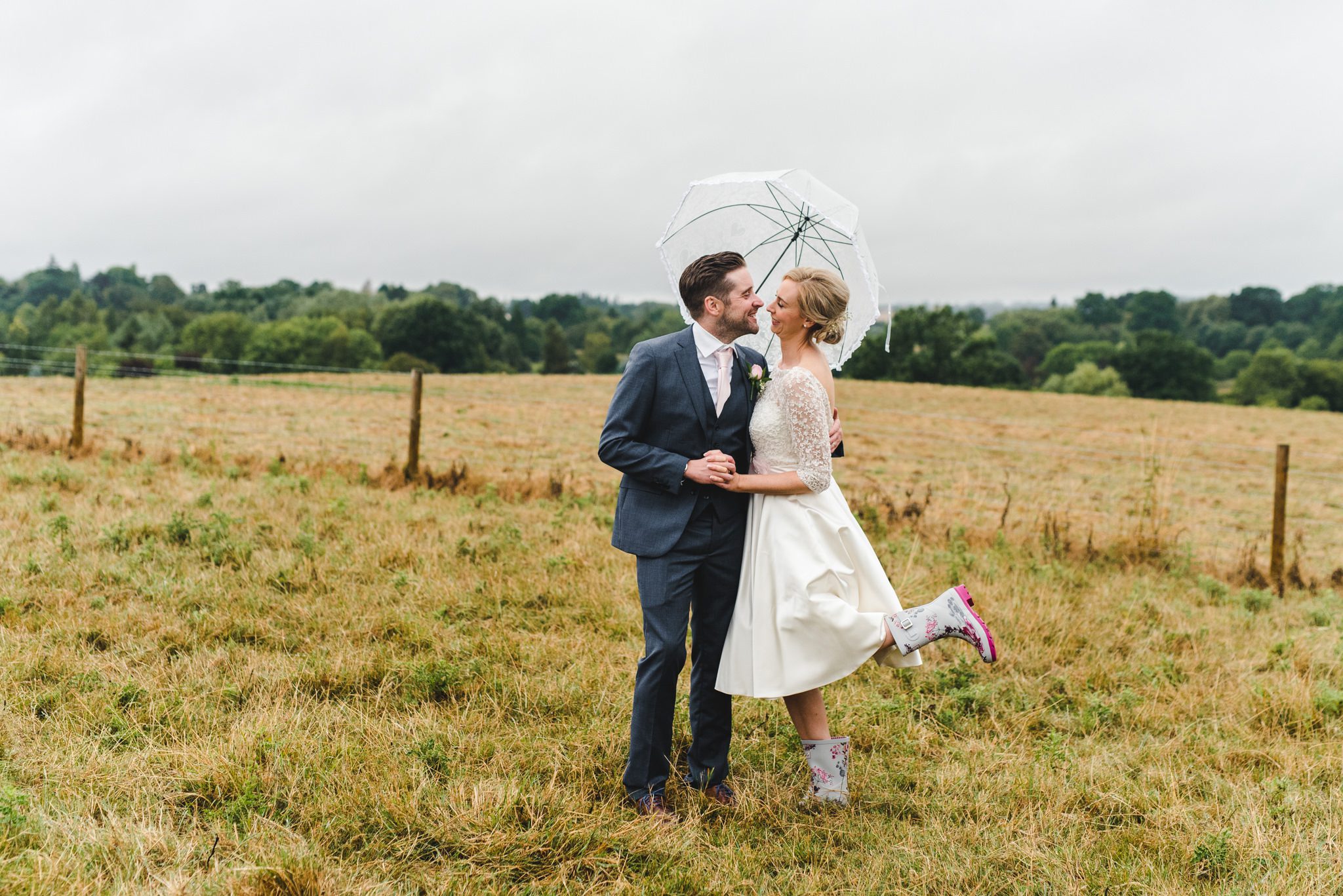 Windswept field photographs with a bride and groom