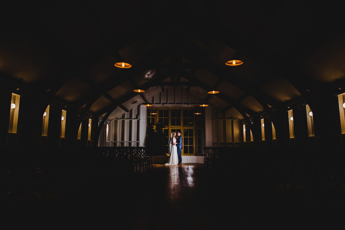 A bride and groom in the grange at Hyde House