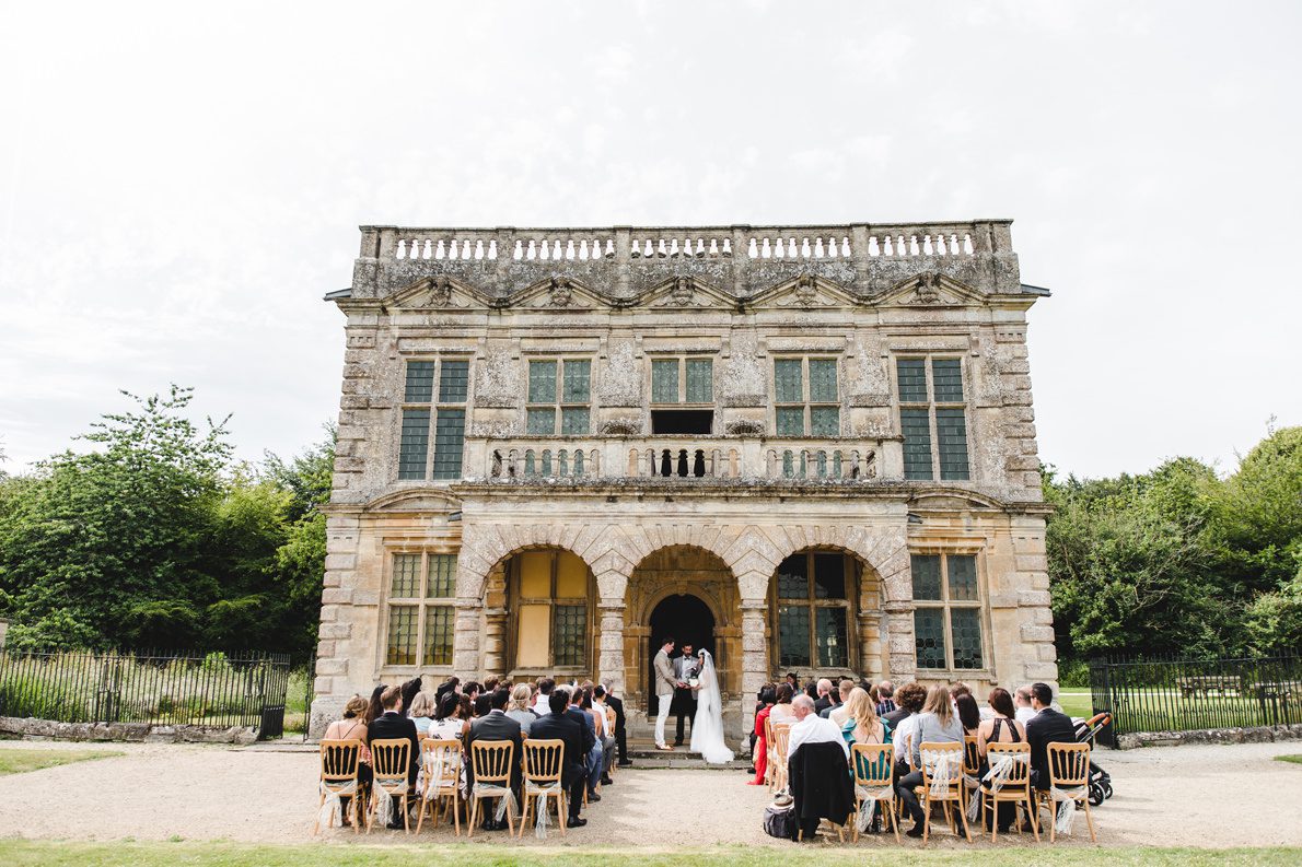 An outdoor wedding ceremony at the front of lodge park